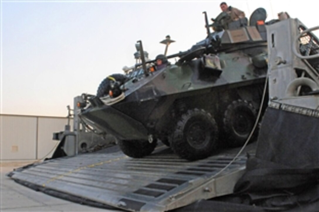 U.S. Marines unload a light armored vehicle from the back of an land craft, air-cushioned hovercraft., Camp Patriot, Kuwait., Oct. 12, 2008. The Marines use the vehicle as part of a combat arms system to provide anything from troop transportation to combat support. 