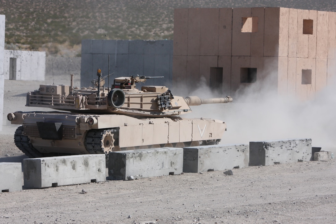 An M1A1 Abrams Main Battle Tank fires a round down rage during tank and infantry integration training at Range 210 Oct. 23. Australian soldiers of Squadron A, 1st Armoured Regiment, joined the Marines in the training.