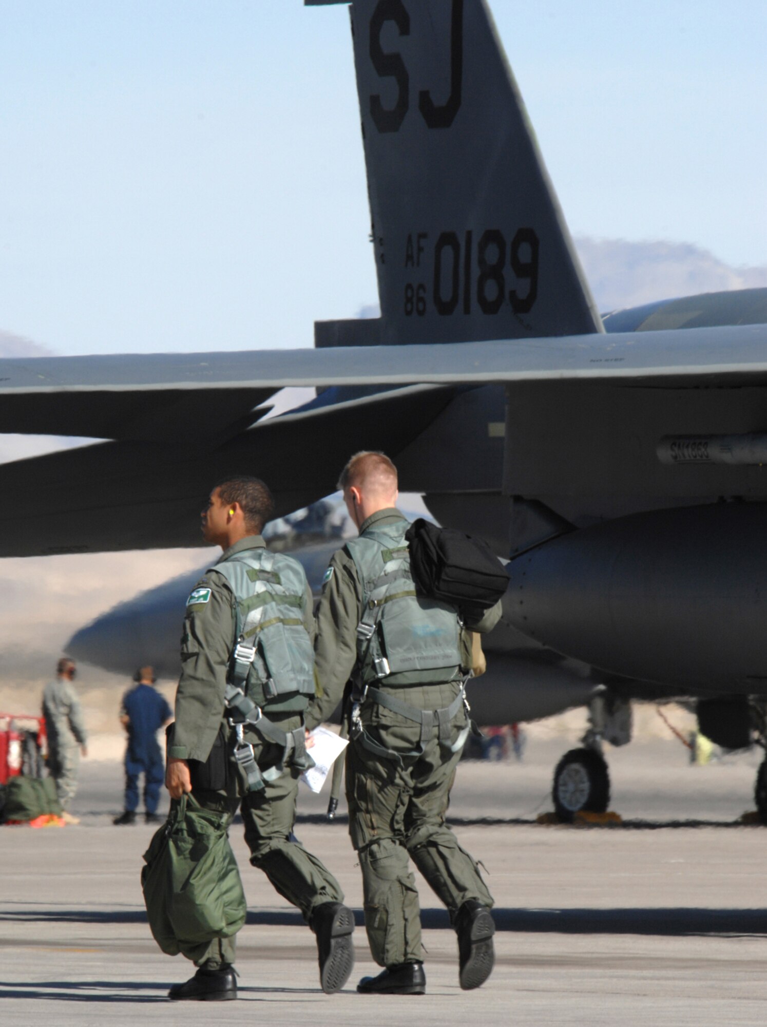 Two F-15E pilots assigned to the 335th Fighter Squadron, Seymour Johnson Air Force Base, N.C., walk out to their aircraft in preparation for a training mission during Red Flag 09-1 at Nellis AFB, Nev., Oct. 22, 2008. Red Flag is a multi-national exercise providing a realistic environment to practice combat scenarios. The experience gained during the exercise is vital to the survival of pilots in combat.
(U.S. Air Force Photo/Senior Airman Larry E. Reid Jr.)