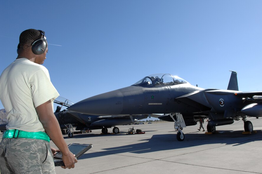 Airman 1st Class Jaguar Philpot, an F-15E specialist assigned to the 4th Aircraft Maintenance Squadron at Seymour Johnson Air Force Base, N.C., reads aircraft data before take off during Red Flag at Nellis Air Force Base, Nev., Oct. 22. Red Flag is a multi-national exercise providing a realistic environment to practice combat scenarios. The experience gained during the exercise is vital to the survival of pilots in combat. (U.S. Air Force Photo by Senior Airman Larry E. Reid Jr.) 

