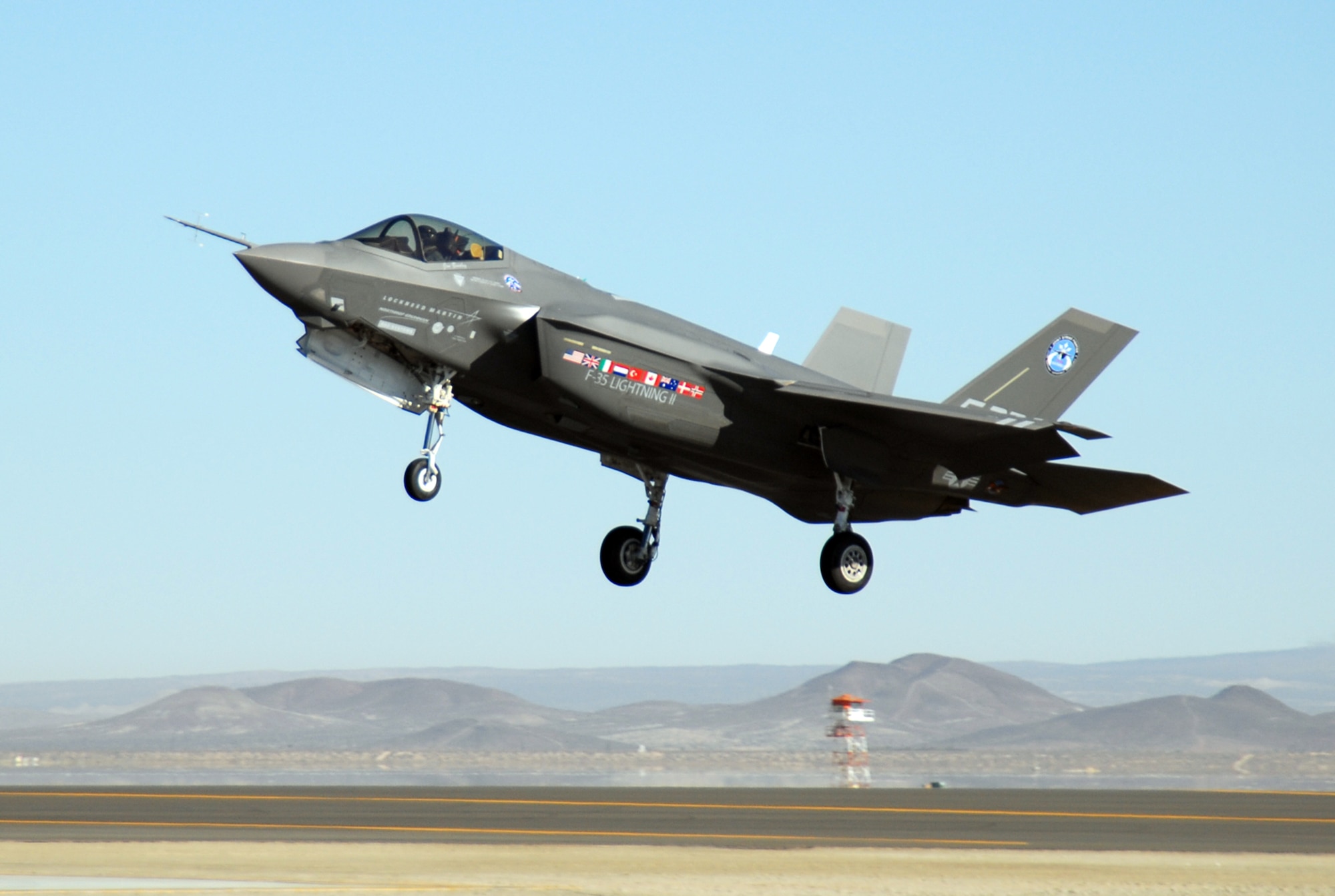An F-35 Lightning II, marked AA-1, lands at an Edwards runway Oct. 23. The F-35 concluded an air start test validating the aircraft's ability to shutdown and restart its engine in flight. (Air Force photo by Senior Airman Julius Delos Reyes)