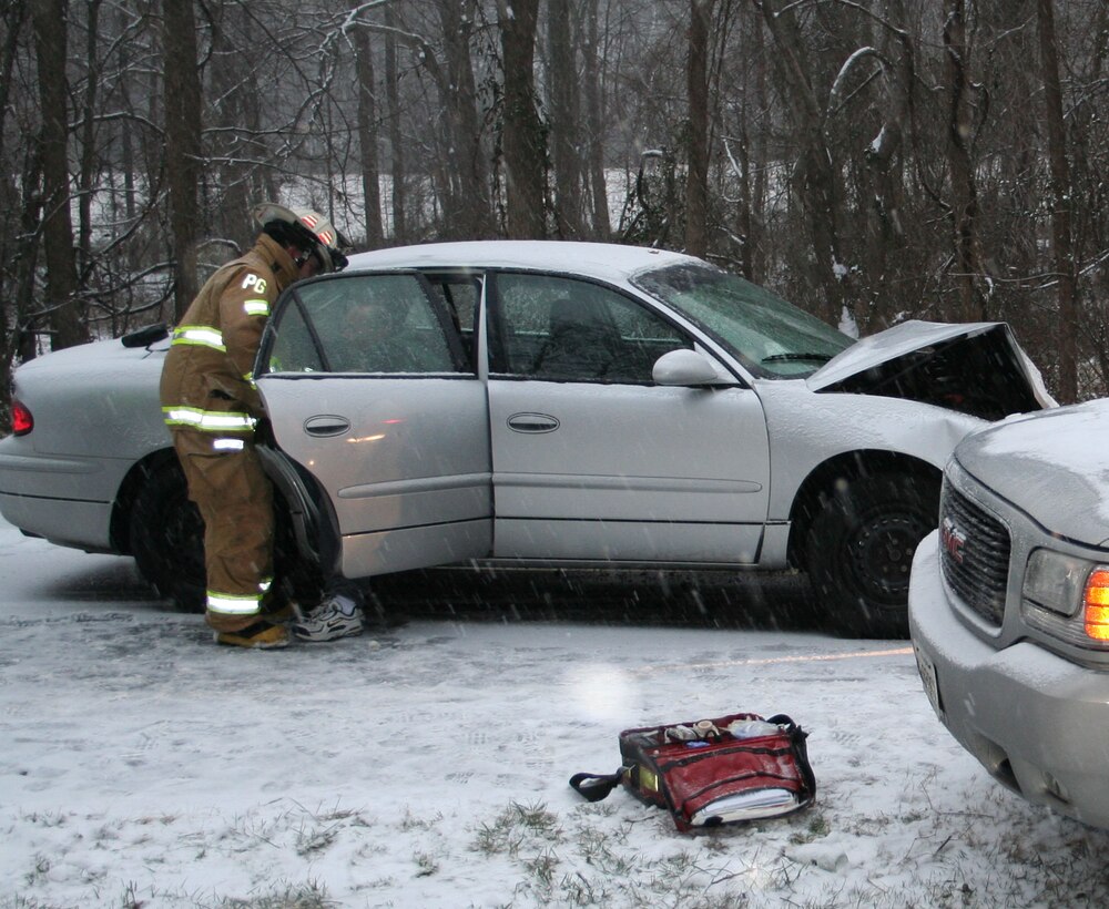 Tech. Sgt. Keith O’Daniel, air transportation specialist with 89th Aerial Port Squadron and volunteer Forestville firefighter, works on a car accident victim after a crash on South Osborne Road in Upper Marlboro, Md Jan. 21, 2007. (Courtesy photo)