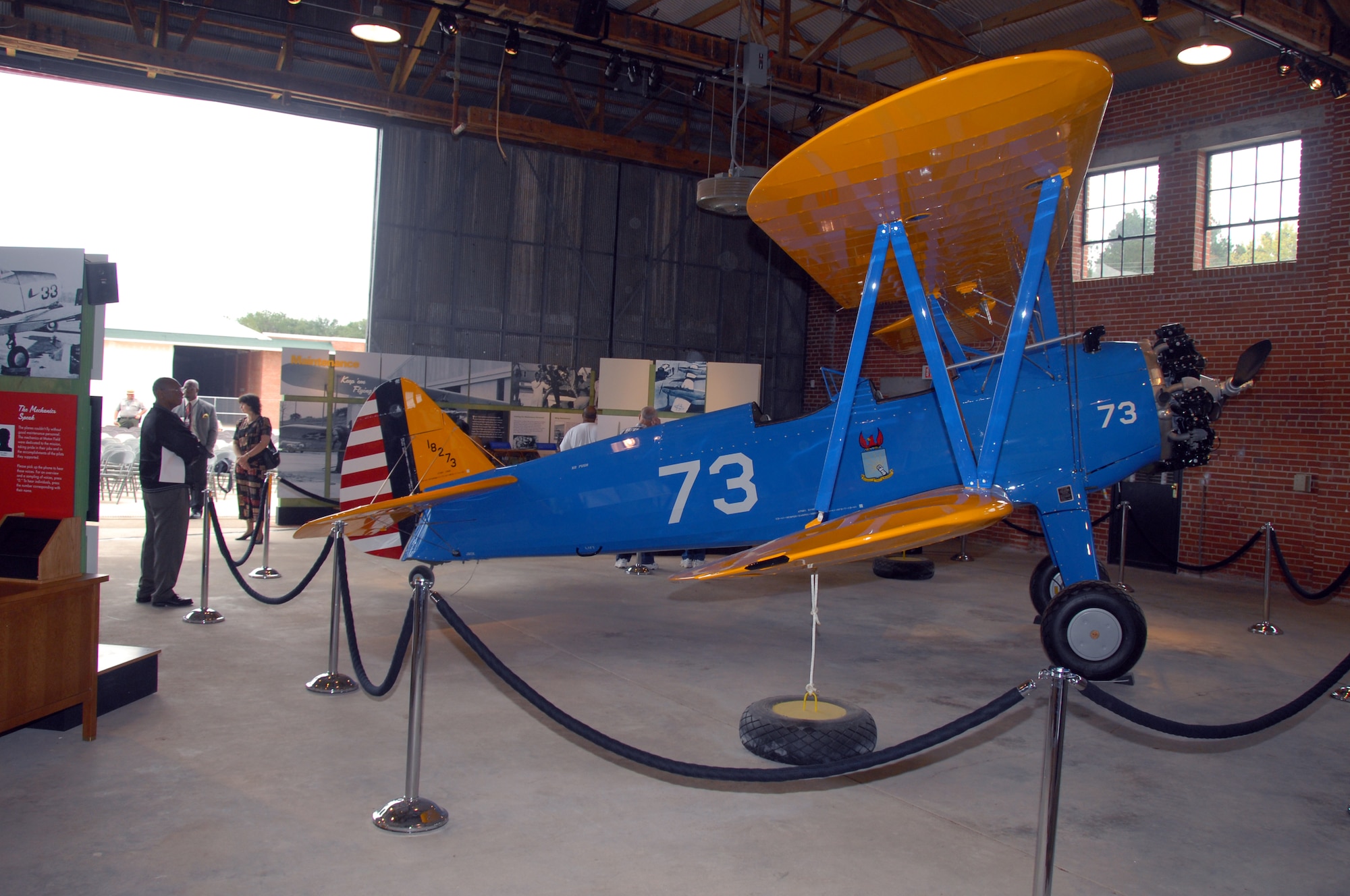 After the opening activities of the Tuskegee Airmen National Historic Site at Moton Field, Ala., visitors explore the interpretive and static displays such as this Stearman P-17 trainer housed the in the only remaining original hangar Oct. 11.  (U.S. Air Force Photo by Lt. Col. Jerry Lobb)         
