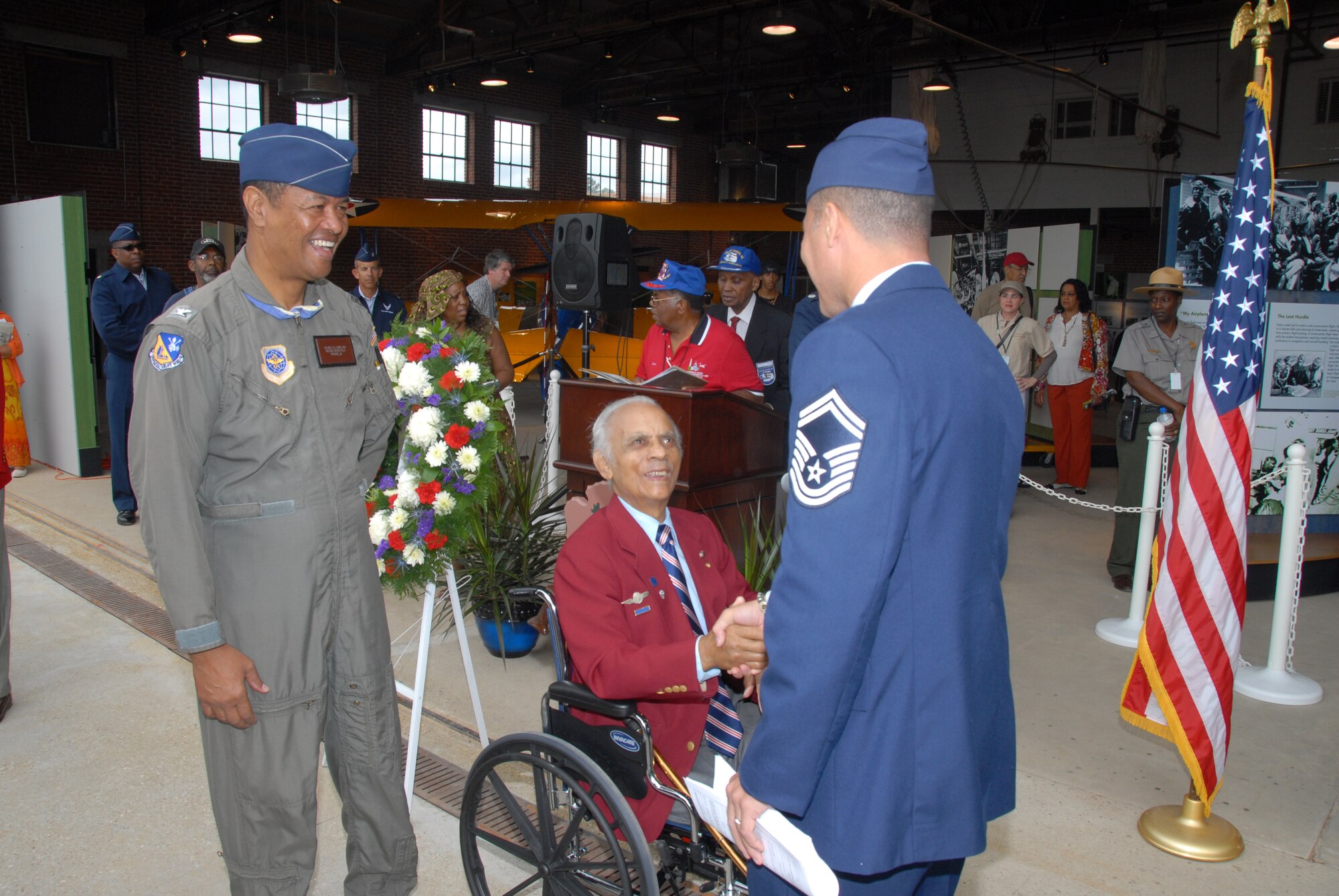 Retired Lt. Col. Herbert E. Carter, accompanied by retired Col. R.J. Lewis,  shakes hands with Senior Master Sgt. Mark Lanton after administering the oath of enlistment to Sergeant Lanton and 10 908th Airlift Wing people who either enlisted or re-enlisted Oct. 11 at Moton Field in Tuskegee, Ala. Colonel Carter, an original Tuskegee Airman, is a former commander of the AFROTC detachment at Tuskegee, longtime university official as well as president of the Tuskegee chapter of Tuskegee Airmen Inc. He was on hand for the three-day grand opening of the Tuskegee Airmen National Historic Site. Colonel Lewis, a second generation Tuskegee Airman, is the airfield manager at Moton Field.  (U.S. Air Force Photo by Lt. Col. Jerry Lobb)         