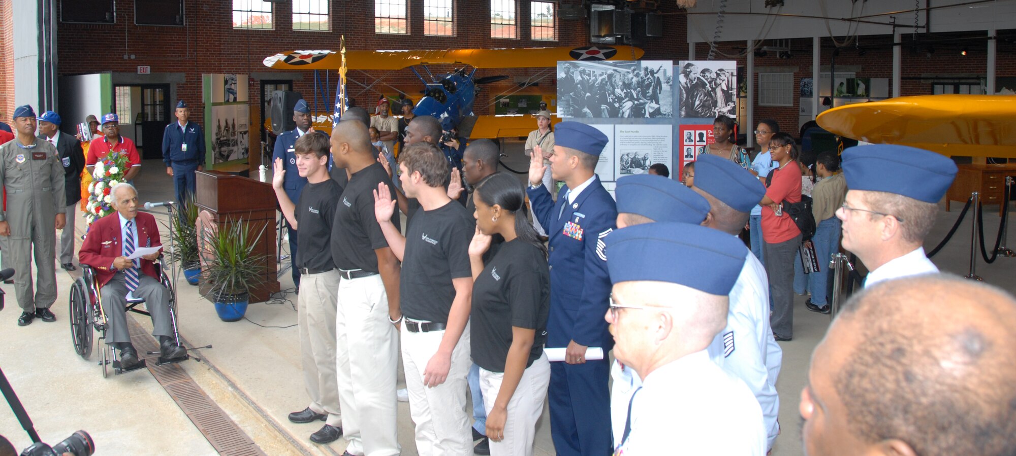Retired Lt. Col. Herbert E. Carter administers the oath of enlistment to 11 908th Airlift Wing people who either enlisted or re-enlisted Oct. 11 at Moton Field in Tuskegee, Ala. Colonel Carter, an original Tuskegee Airman, is a former commander of the AFROTC detachment at Tuskegee, longtime university official as well as president of the Tuskegee chapter of Tuskegee Airmen Inc. He was on hand for the three-day grand opening of the Tuskegee Airmen National Historic Site. (U.S. Air Force Photo by Lt. Col. Jerry Lobb)         