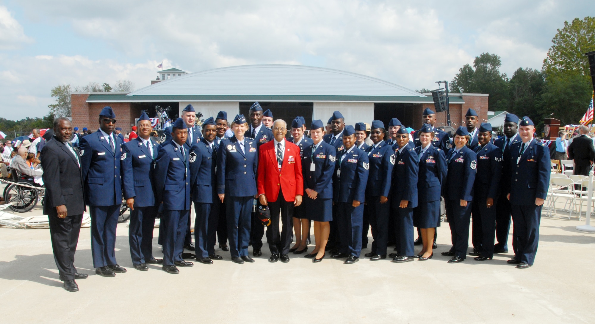 Maj. Gens. Linda S. Hemminger and Harold L. "Mitch" Mitchell along with 908th Airlift Wing members including former 908th AW Command Chief Amos Moore pose for a keepsake photo with original Tuskegee Airman retired Col. Charles McGee.  Colonel McGee has the distinction of being the Air Force's record-holder for the highest number of combat missions flown in three wars. General Hemminger is the mobilization assistant to the Air Force deputy surgeon general; General Mitchell is mobilization assistant to the commander, U.S. Transportation Command. (U.S. Air Force Photo by Lt. Col. Jerry Lobb)         