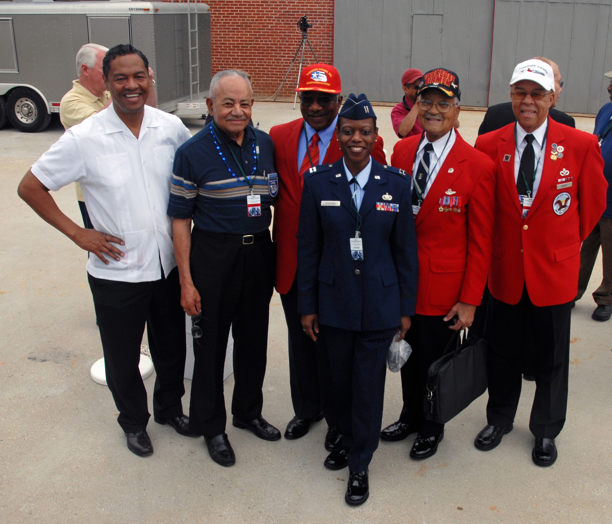 Capt. Tonia Stephens poses for a keepsake photo with a group of original Tuskegee Airmen and retired Air Force Col. R. J. Lewis, far left, before the opening ceremony of the Tuskegee Airmen National Historic Site Oct. 10 at Moton Field, Tuskegee, Ala. Captain Stephens is a member of the 908th Airlift Wing; Colonel Lewis is a second generation Tuskegee Airman and longtime airfield manager at Moton Field. (U.S. Air Force Photo by Lt. Col. Jerry Lobb)         