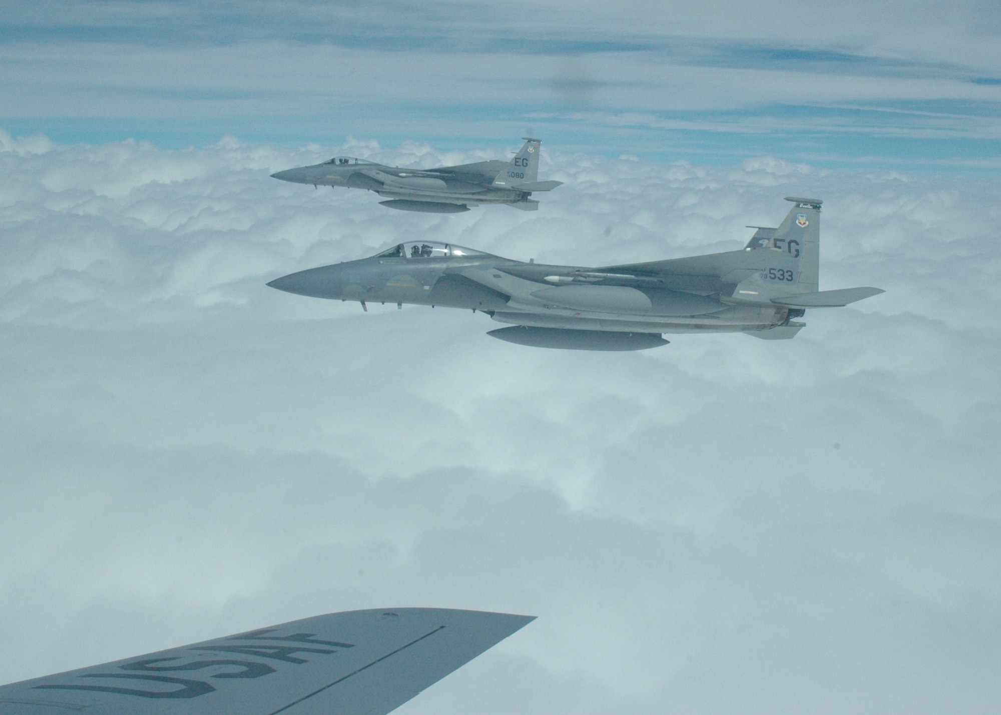 Two F-15 Eagles from the 33d Fighter Wing, Eglin Air Force Base, Fla. fly away after being refueled in air by a KC-135 from the 74th Air Refueling Squadron at Grissom Air Reserve Base, Ind. (U.S. Air Force photo/Chrissy Cuttita)