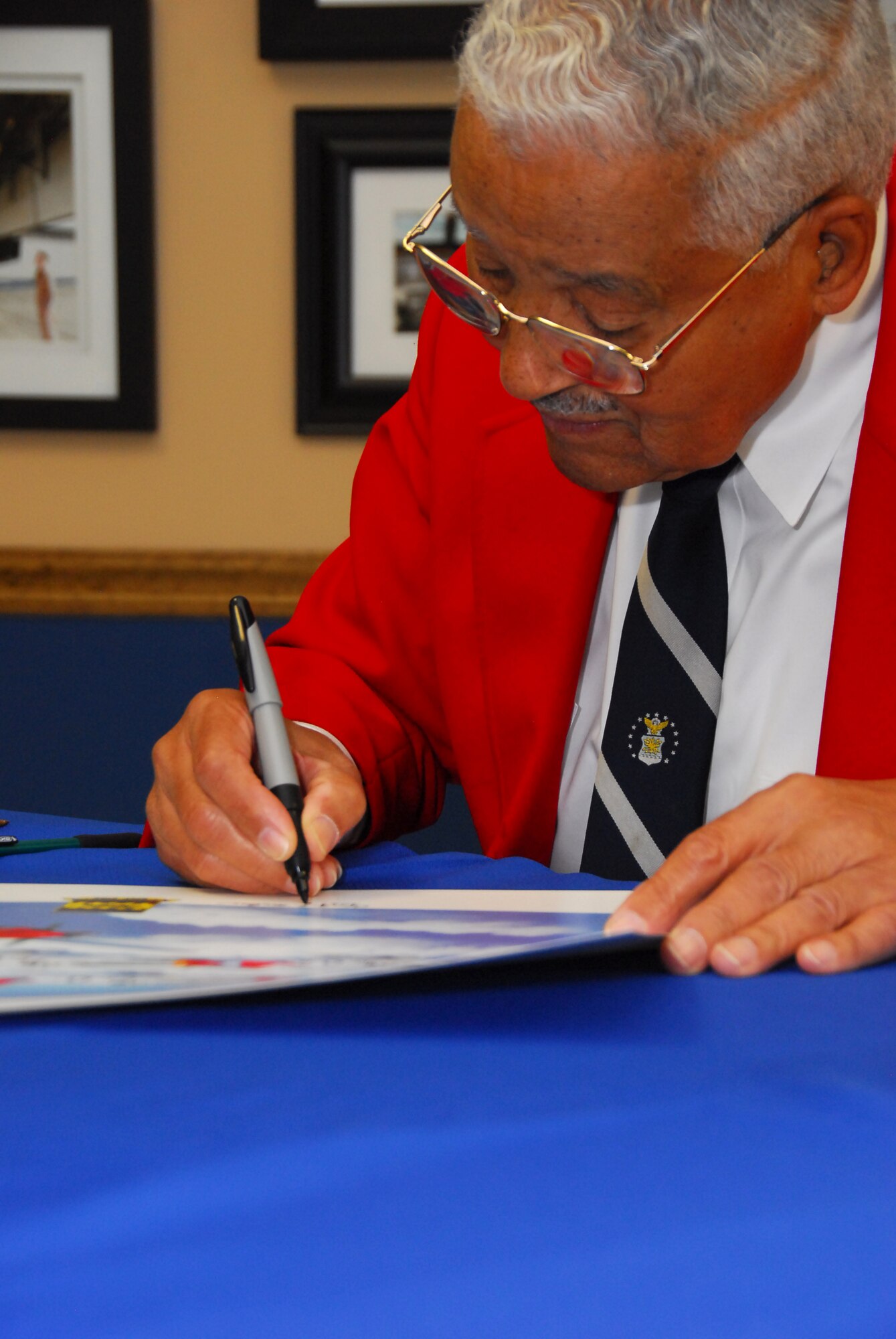 Retired Col. Charles McGee, one of the original Tuskegee Airmen, signs autographs after speaking to Squadron Officer School students at the Warrior Symposium Oct. 16.  (Air Force photo by Scoot Knuteson)