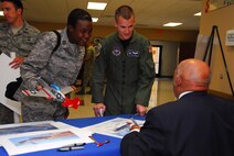 Capt. Roslynn Rayford and Capt. Tony Weedn speak to retired Lt. Col. William Holloman, one of the original Tuskegee Airmen who addressed scores of captains completing their training at Squadron Officer School.  (Air Force photo by Scoot Knuteson)