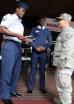 Staff Sgts. Bryan Hawk (from left) and Beonville Rouger, paralegals, talk with Tech. Sgt. Edward Timmons during the 2008 Texas Paralegal Day.