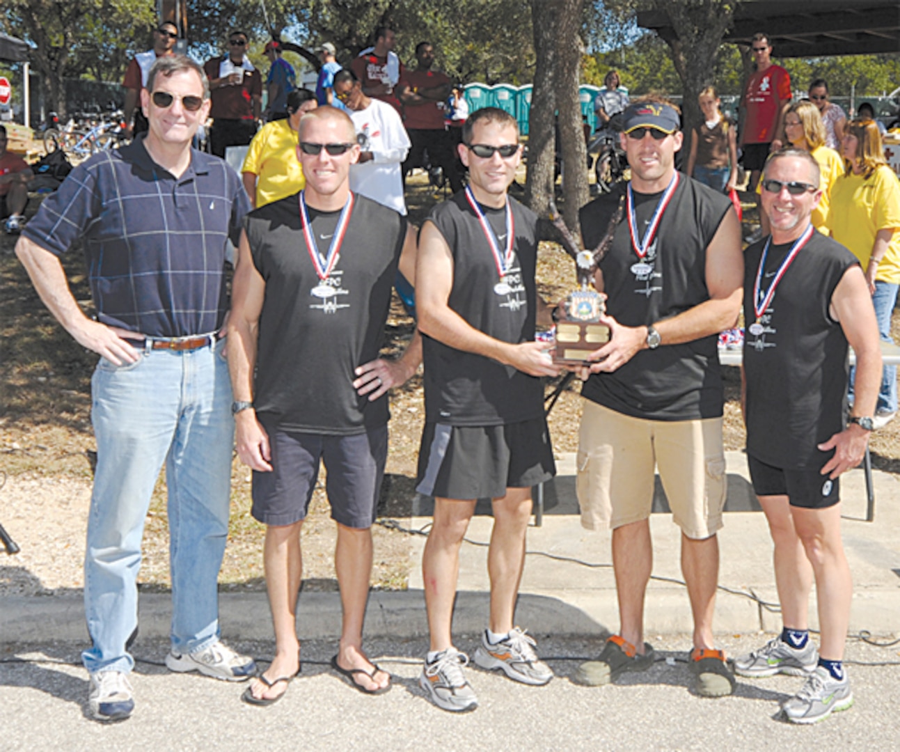 From left to right: Gen. Stephen Lorenz, Air Education and Training Command commander, awarded the top trophy to the Air Force Personnel Center?s ?Flesh Peddlers:? Steve Frank, Drew Martin, Tim Moser and Bill Relyea. Flesh Peddlers finished the competition with the fastest overall time of 2:19:47. Participants from four U.S. Air Force Bases competed in the triathlon held each year at Canyon Lake. (U.S. Air Force photo by Steve White)