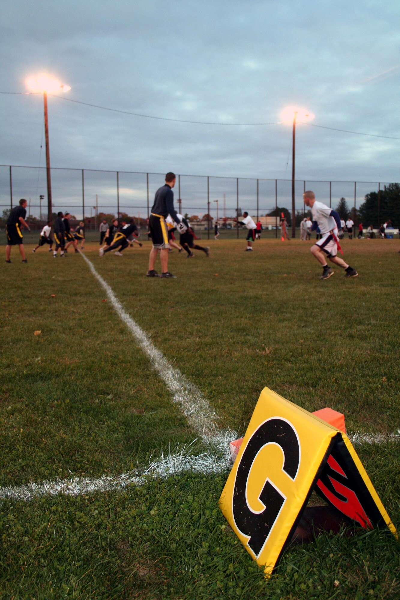Team members from the U.S. Air Force Expeditionary Center's "Screaming Eagles" intramural flag football team (in white) start a play near the goal line during football action Oct. 22, 2008, against the 305th Services Squadron on McGuire Air Force Base, N.J.  The USAF EC defeated McGuire Services 12-6 to improve to 9-3 on the season.  (U.S. Air Force Photo/Tech. Sgt. Scott T. Sturkol)