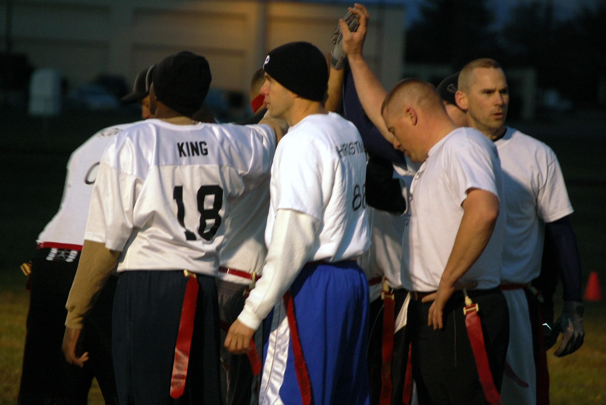 Team members from the U.S. Air Force Expeditionary Center's "Screaming Eagles" intramural flag football team huddle up during a time out from football action Oct. 22, 2008, against the 305th Services Squadron on McGuire Air Force Base, N.J.  The USAF EC defeated McGuire Services 12-6 to improve to 9-3 on the season.  (U.S. Air Force Photo/Tech. Sgt. Scott T. Sturkol)