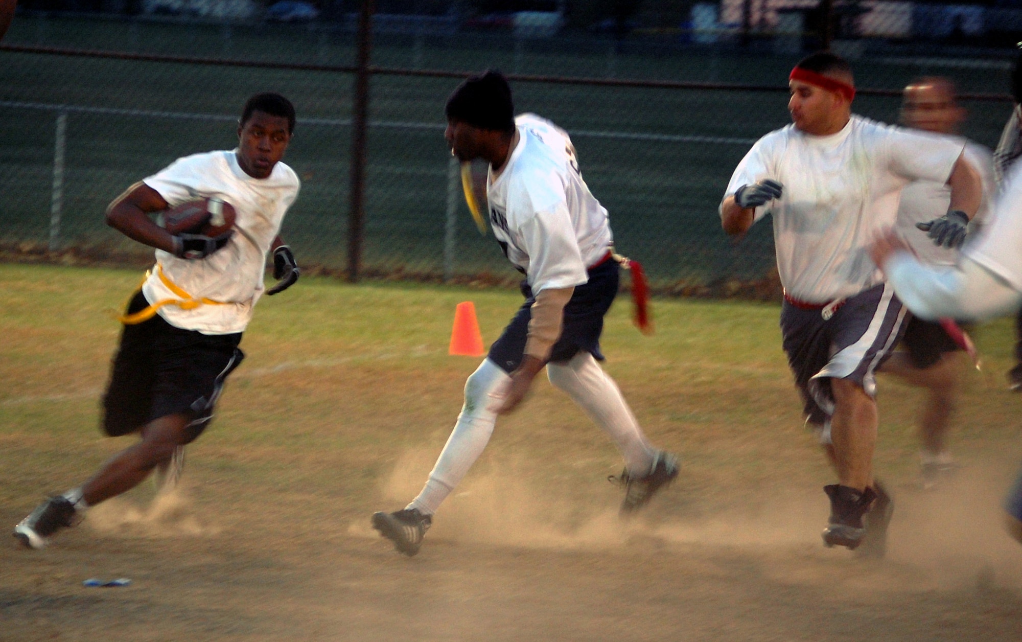 Rayshawn King and Eric Bergery (right) from the U.S. Air Force Expeditionary Center's "Screaming Eagles" intramural flag football team chase down an opponent during football action Oct. 22, 2008, against the 305th Services Squadron on McGuire Air Force Base, N.J.  The USAF EC defeated McGuire Services 12-6 to improve to 9-3 on the season.  (U.S. Air Force Photo/Tech. Sgt. Scott T. Sturkol)