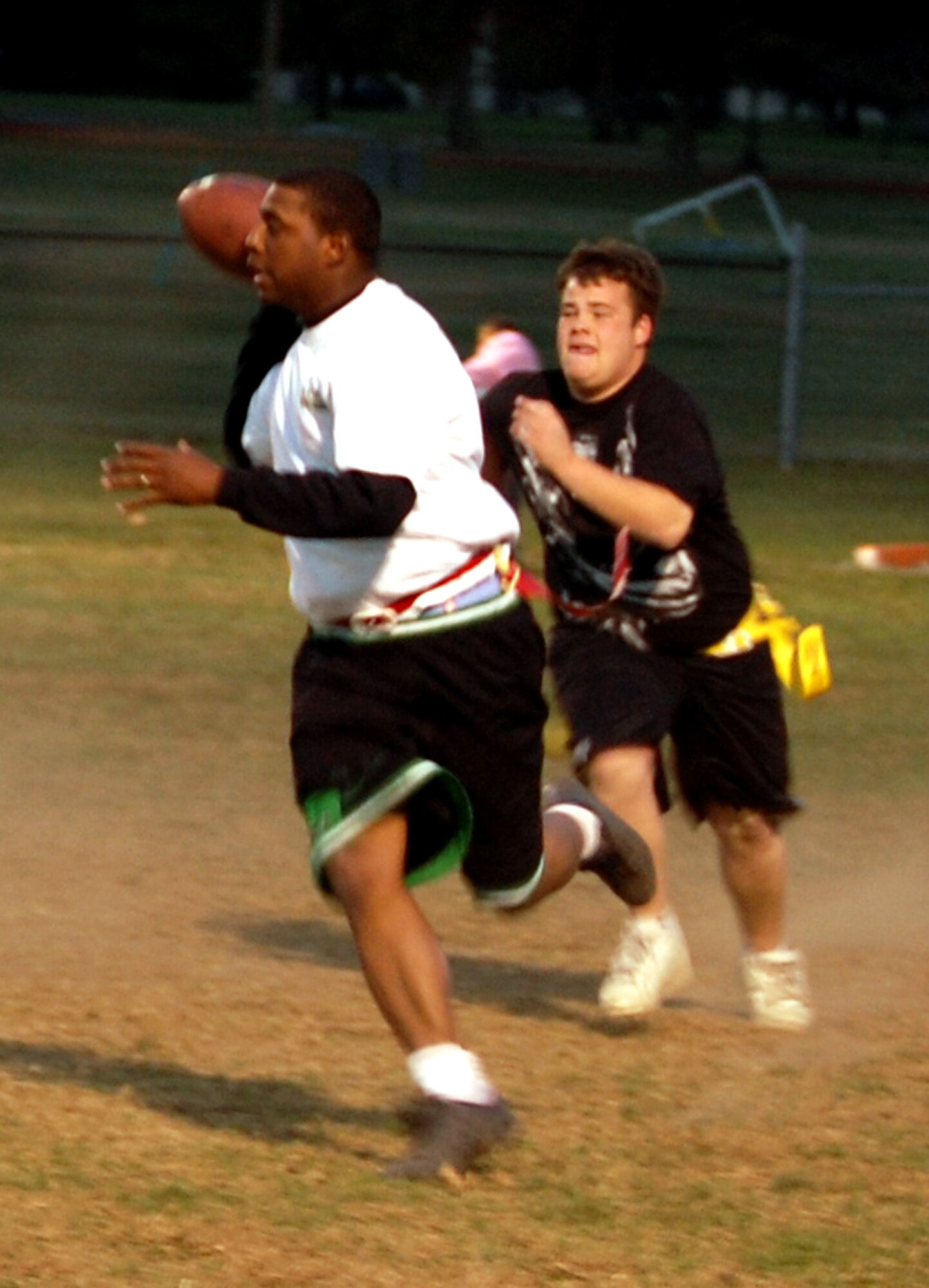 Quarterback Cecil Evans from the U.S. Air Force Expeditionary Center's "Screaming Eagles" intramural flag football team scrambles to through a pass during football action Oct. 22, 2008, against the 305th Services Squadron on McGuire Air Force Base, N.J.  The USAF EC defeated McGuire Services 12-6 to improve to 9-3 on the season.  (U.S. Air Force Photo/Tech. Sgt. Scott T. Sturkol)
