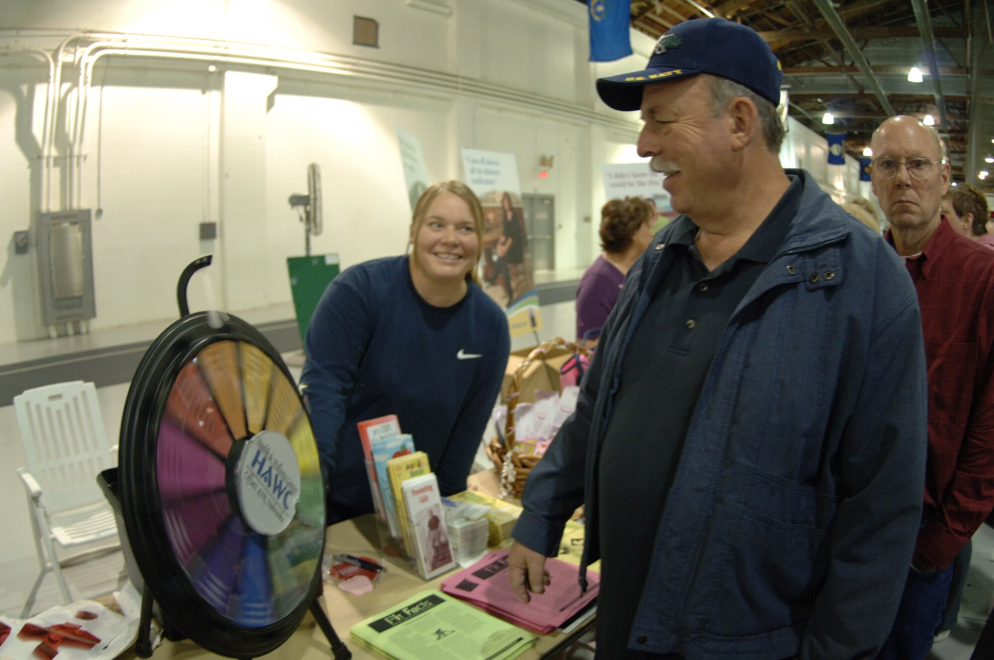 Retired Navy Senior Chief Petty Officer Douglas Hai spins the health assessment wheel at the annual Retiree Appreciation Day Oct. 19 as Kristine Sorenson, Aerospace Medicine Squadron health and fitness specialist, watches.  Retired service members and their families come to Offutt every year for this event, which provides them with information from briefings, booths and base tours as well flu shots from the 55th Medical Group.  (U.S. Air Force Photo By Tech. Sgt. Rhonda Moraski)