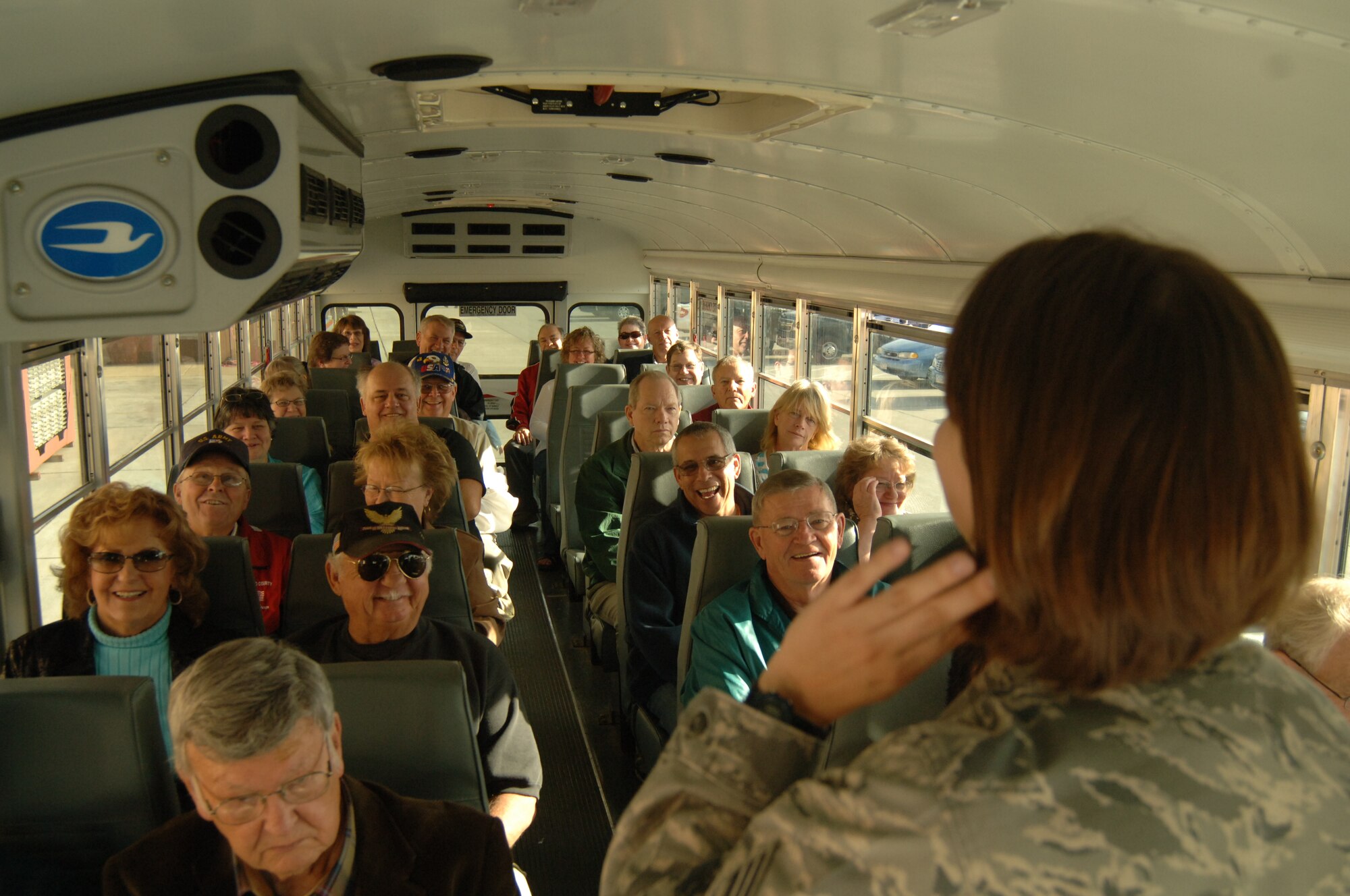 Senior Airman Amanda Dick, 55th Wing Public Affairs community relations journeyman, listens to questions from a group of retired military members and their families during a base tour that was a part of this year’s Retiree Appreciation Day Oct. 19. Services offered at this annual event include briefings and booths from the retiree affairs office, the airman and family readiness center, various veterans’ affairs offices and TRICARE among others as well as base tours and flu shots from the 55th Medical Group. (U.S. Air Force Photo By Tech. Sgt. Rhonda Moraski)