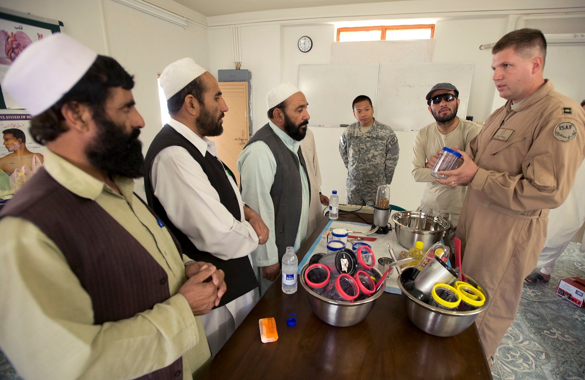 Capt. (Dr.) James Arnold shows medical professionals from the Zaubl province how to make "strong food" Oct. 15 in Qalat, Afghanistan. "Strong food" is a vitamin enriched high calorie food supplement used to combat malnutrition. The Zabul Provincial Reconstruction Team medical staff is working with local heath officials to combat the main causes of the extremely high-infant mortality in the area such as unsanitary water supplies and malnutrition. Captain Arnold is deployed from Andersen Air Force Base, Guam. (U.S. Air Force photo/Master Sgt. Keith Brown) 

