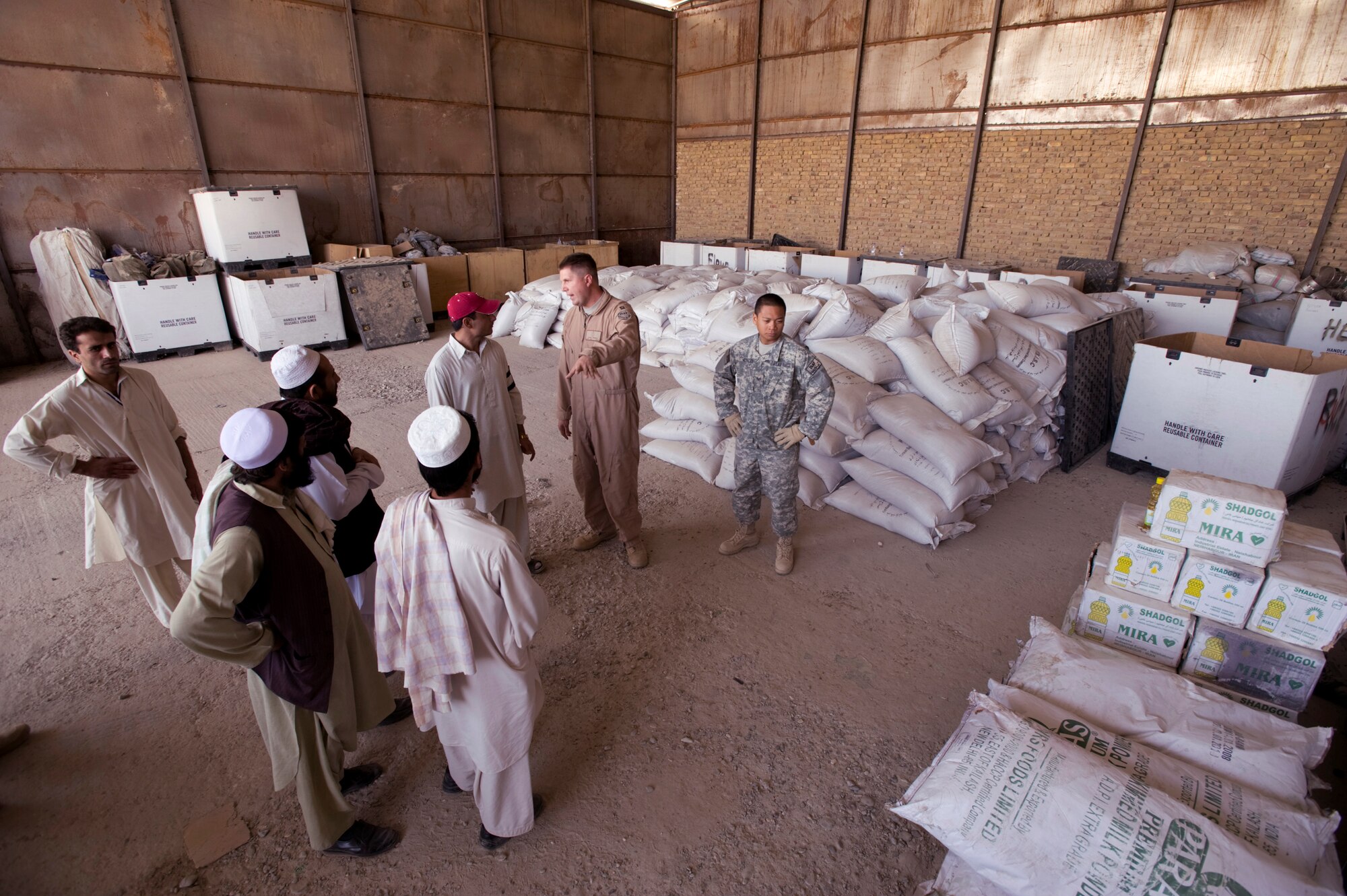 Members of the Zabul Provincial Reconstruction Team medical staff discuss how to divide up ingredients with local medical professionals Oct. 14 from the Zabul province hospitals in Afghanistan. The food is vitamin enriched high calorie food supplements to combat malnutrition. The PRT staff is working with local heath officials to combat the main causes of the extremely high-infant mortality in the area such as unsanitary water supplies and malnutrition. (U.S. Air Force photo/Master Sgt. Keith Brown) 
