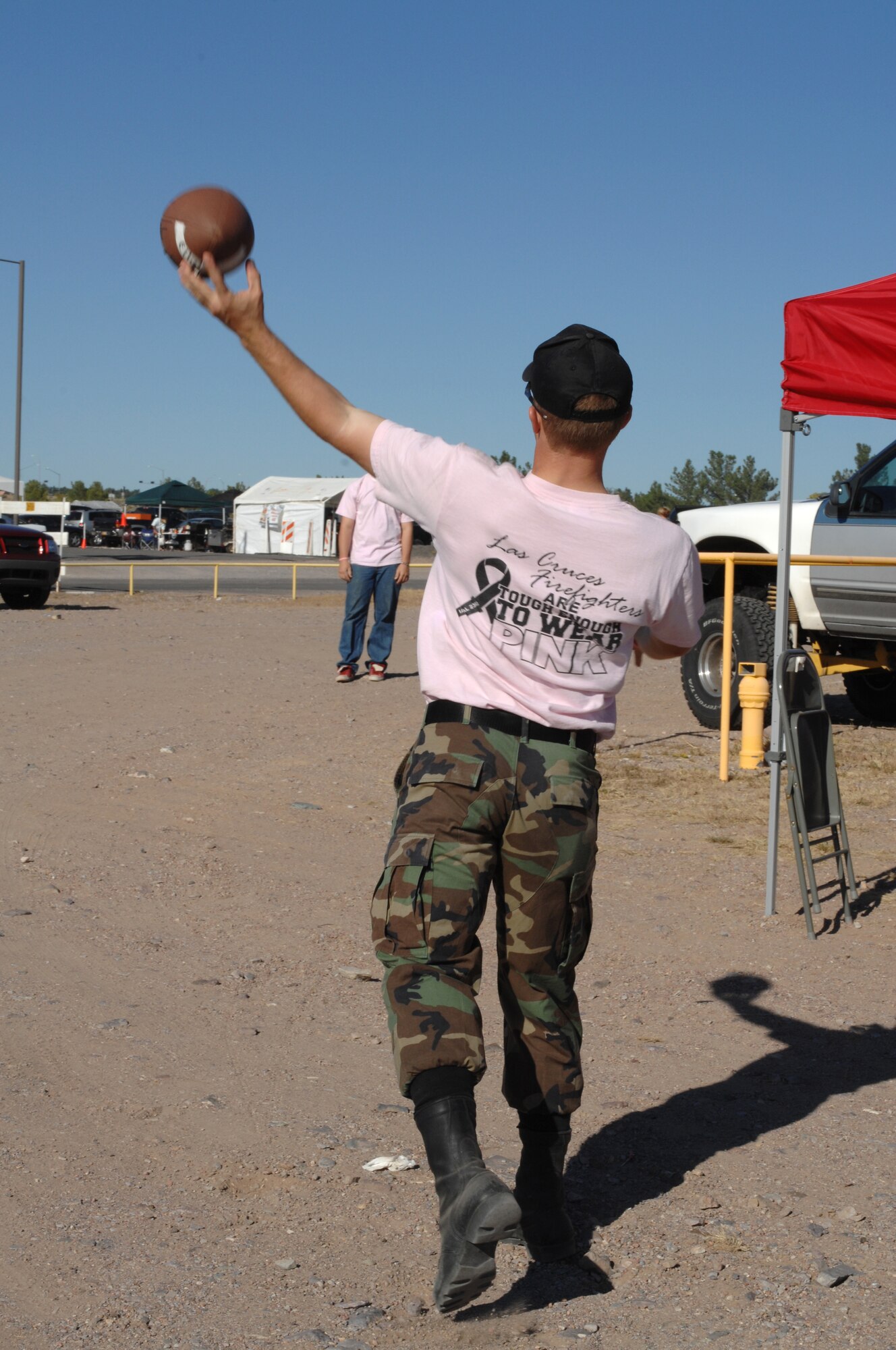 Two reserve officers' training corps cadets from New Mexico State University, toss a football during the tailgate party hosted by Holloman Air Force Base, N.M., 49th Operations Group before the New Mexico State University game against San Jose State at NMSU, October 18. More than 80 Team Holloman Airmen, family and friends attended the party. (U.S. Air Force photo/Airman Sondra M. Escutia)