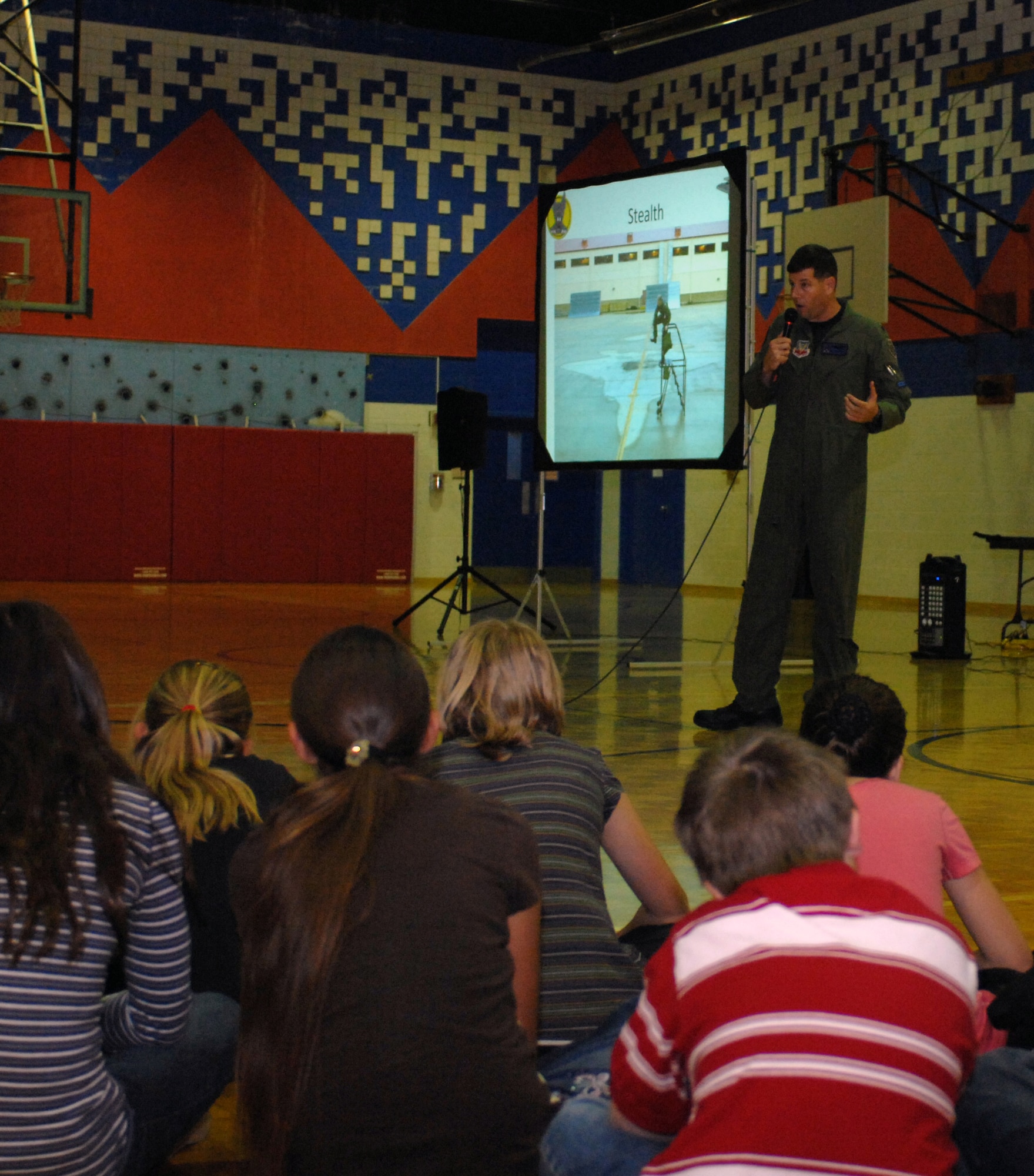 Lt. Col. Mike Hernandez, 7th Fighter Squadron commander from Holloman Air Force Base, N.M., speaks to third and fourth graders at White Mountain Elementary School students, October 21. Colonel Hernandez taught the children about the F-22A Raptor, its capabilities and about the sonic booms it produces. (U.S. Air Force photo/Airman Sondra M. Escutia)