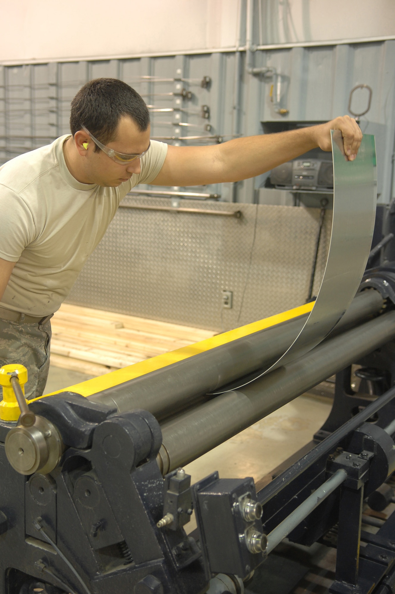 Airman 1st Class Joseph Williams, 4 Equipment Maintenance Sqaudron, uses a power slip form roller to shape a piece of aluminum on Seymour Johnson Air Force Base, NC.., Oct. 21, 2008. A1C Williams was preparing to use the aluminum as a fuselage patch for an F-15 Eagle. (U.S. Air Force photo by Airman 1st Class Makenzie Lang)