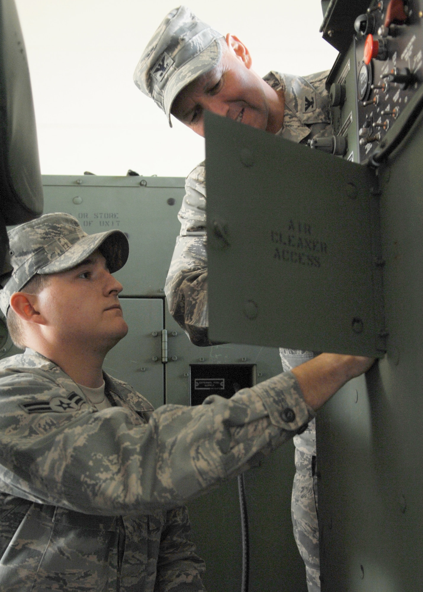 Airman 1st Class Wilson Jackson, 606th Air Control Squadron, inspects a generator with Colonel Lee T. Wight, 52nd Fighter Wing Commander. Airman Jackson spent the day showing the commander his job as part of the Commander’s Shadow program on October 10, 2008. (U.S. Air Force photo by Airman 1st Class Nicholas Wilson)