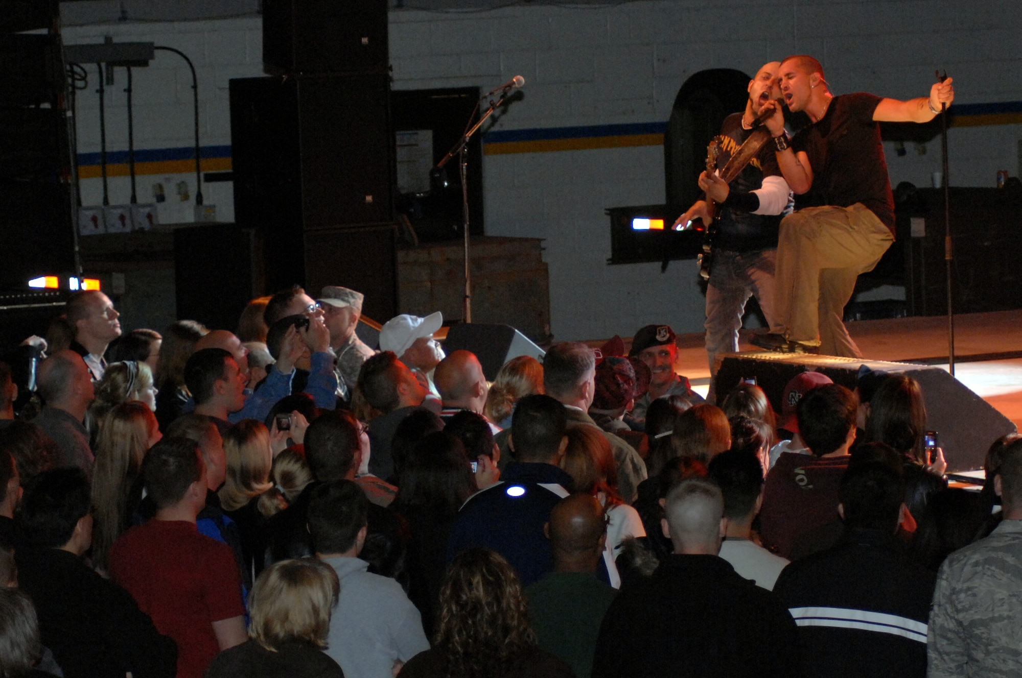 Rock 'n' Roll singer Scott Stapp, formerly of the band Creed,  and Zelick Gimelstein, bass player, harmonize during during an Armed Forces and Navy Entertainment concert for Airmen and their families at RAF Mildenhall, England, Oct. 16, 2008. Stapp's grandfather was in the Navy, his father was in the Air Force, and his sister-in-law is in the Army. While here he said of the military, "These are our heroes, and these people are who I want my children to look up to." (U.S. Air Force photo by Senior Airman Teresa Hawkins)