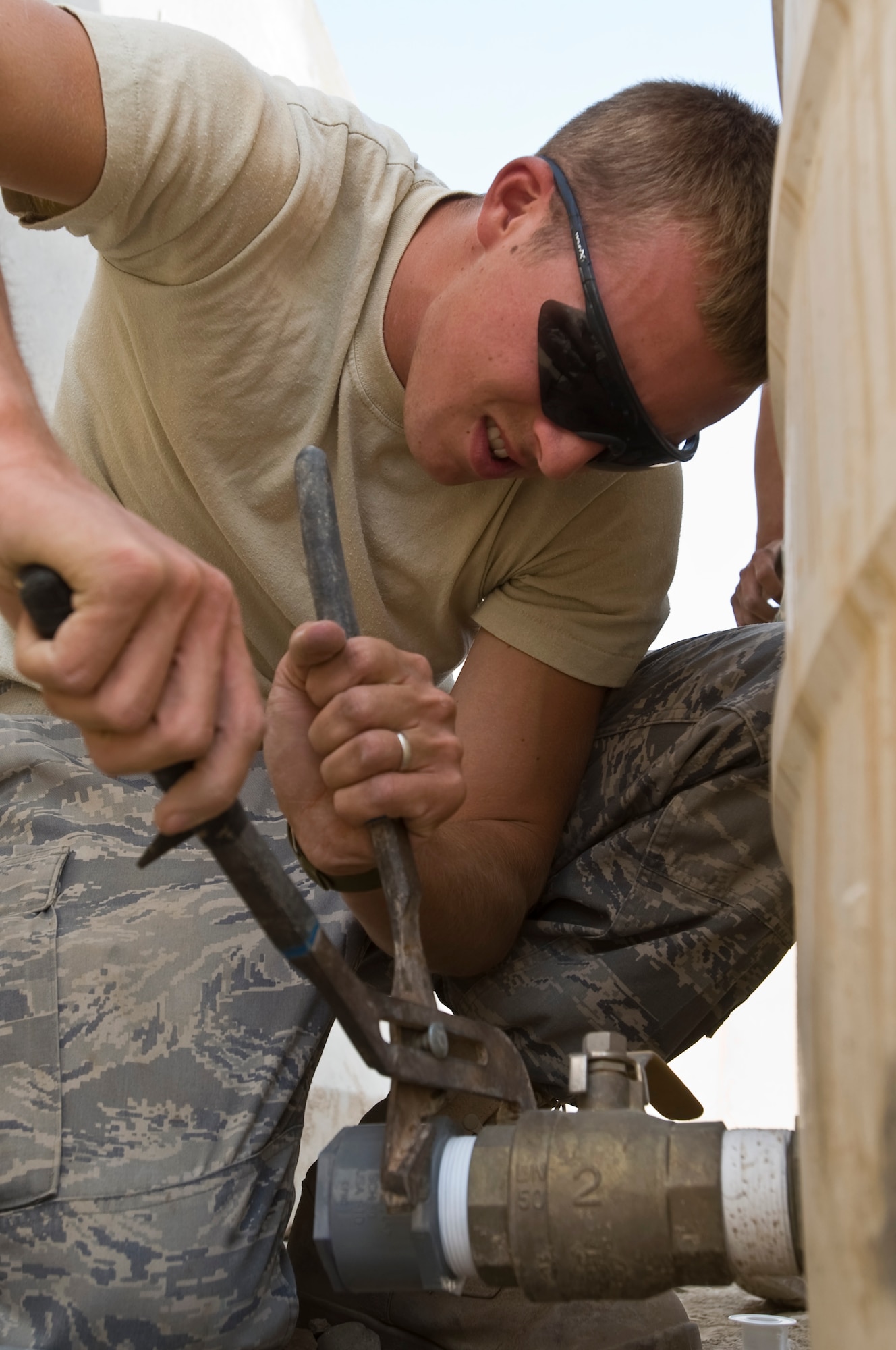 ALI BASE, Iraq -- Airman 1st Class Derek Reed, 407th Expeditionary Civil Engineer Squadron, tightens a water tank adapter Oct. 22, 2008. The water tank will provide running water for a snack bar. People stationed here now have another Army and Air Force Exchange Service store to purchase necessities. Bray is deployed from F.E. Warren Air Force Base, Wyo. (U.S. Air Force photo/Senior Airman Christopher Griffin) 
