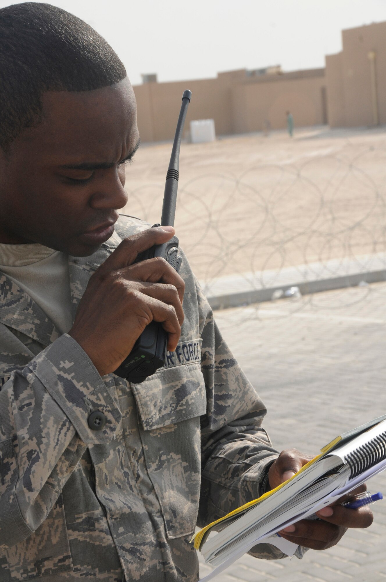 Staff Sgt. Jacques English, optometry technician assigned to the 379th Expeditionary Medical Group, uses his radio and Airman's Manual to report information about unexploded ordinance discovered while conducting a post-attack reconnaissance sweep during a base-wide defense response exercise Oct. 22, at an undisclosed air base in Southwest Asia. PAR teams are responsible for ensuring the perimeter of their facility is safe and assisting any injured personnel found outside. Sergeant English, a native of Fayetteville, N.C., is deployed from the Air Force Academy, Colo., in support of Operations Iraqi and Enduring Freedom and Joint Task Force-Horn of Africa. (U.S. Air Force photo by Staff Sgt. Darnell T. Cannady/Released)