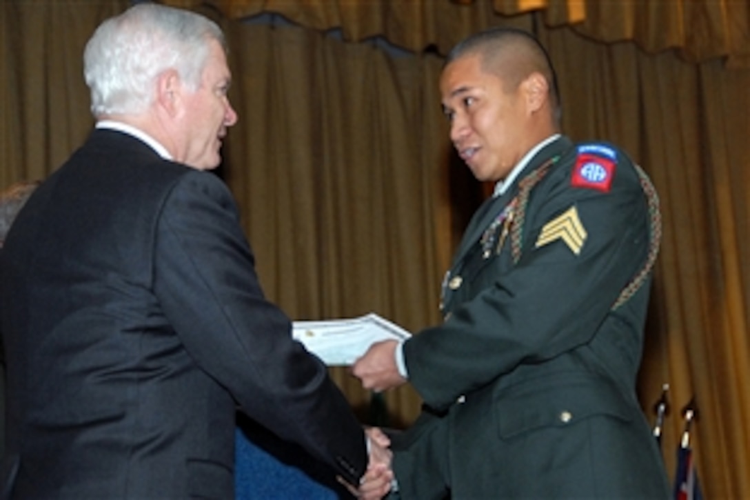 Defense Secretary Robert M. Gates presents Army Sgt. Michael Santos, 82nd Airborne Division, Fort Bragg, N.C., with a certificate of U.S. citizenship during a naturalization ceremony Oct. 23, 2008, at Pope Air Force Base, N.C. Nearly 40 servicemembers representing the Army, Air Force, Navy and Marines became U.S. citizens during the ceremony.