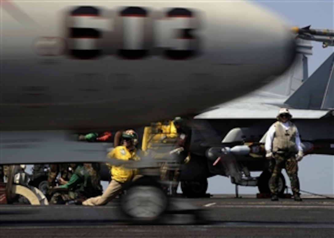 U.S. Navy Lt. Cmdr. Christopher Biggs launches an E-2C Hawkeye aircraft assigned to Carrier Airborne Early Warning Squadron 124 from a bow catapult on the flight deck of the aircraft carrier USS Theodore Roosevelt (CVN 71) while underway in the Gulf of Oman on Oct. 18, 2008.  The Theodore Roosevelt and embarked Carrier Air Wing 8 are on a scheduled deployment.  
