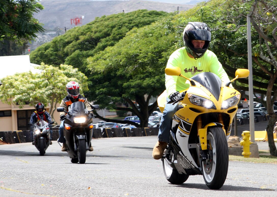 Sgt. Robert Manion, training's nuclear, biological and chemical chief for Headquarters and Service Battalion, U.S. Marine Corps Forces, Pacific and one of the "Ride Safe Club" founders, leads the pack of sports bikes toward the base's front gate for their monthly ride Oct. 24.