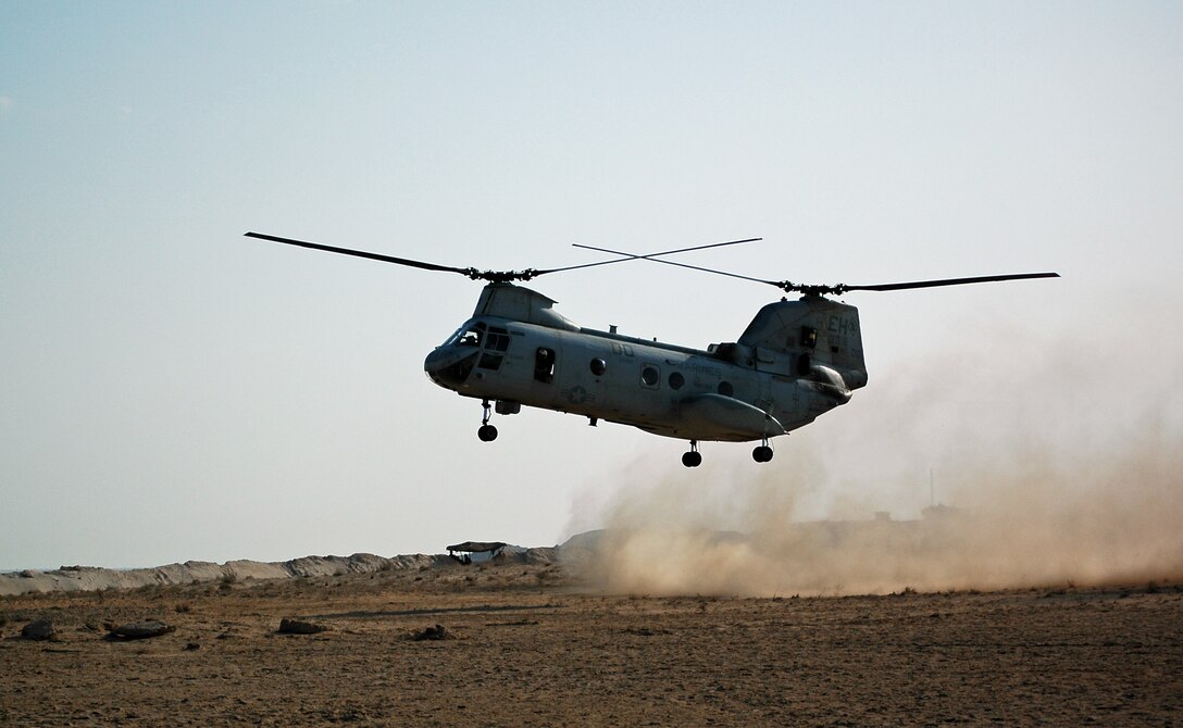 Colonel Mark Desens, 26th Marine Expeditionary Unit commanding officer, brings in a CH-46E Sea Knight helicopter to a dusty landing at one of many training sites during a recent bilateral training exercise. Desens conducted a leader's recon of the entire training area, spanning three points more than 50 miles apart each.