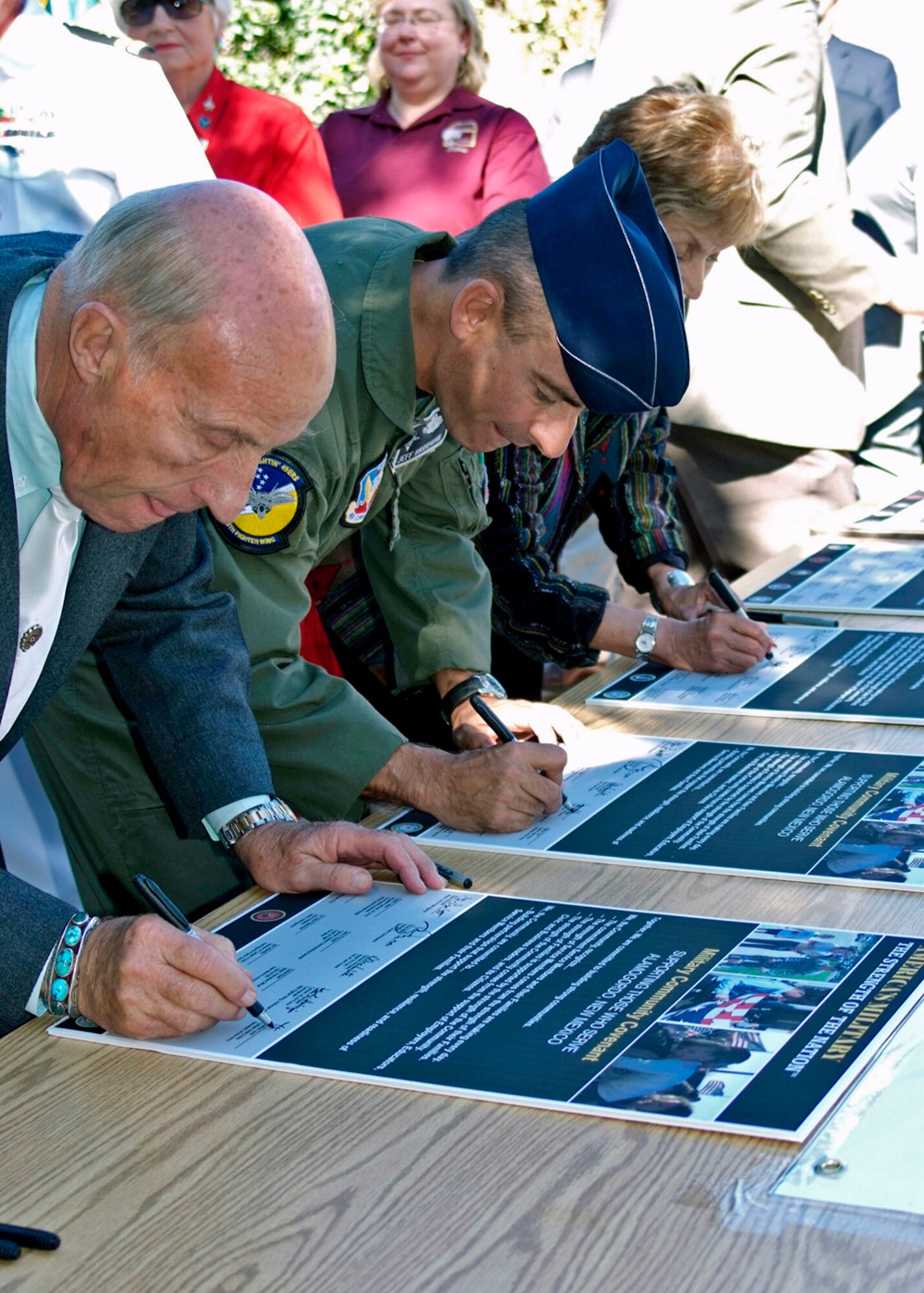 Col. Jeff Harrigian, 49th Fighter Wing commander, signs the Army Community Covenant with Mahlon Love, Civilian Aide to the Secretary of the Army for the State of New Mexico at the Alameda Zoo, N.M., October 18. Alamogordo community officials and military members attended the ceremony to show their support and commitment for Soldiers and their families. (White Sands Missile Range photo by Tom Fuller)