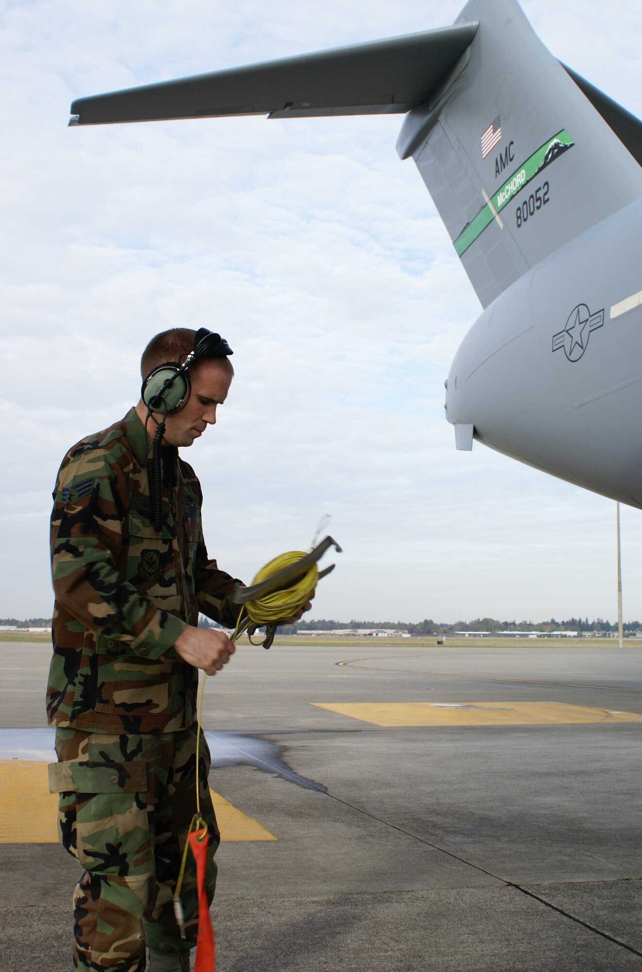 Senior Airman Sheffey Martin, 62nd Aircraft Maintenance Squadron, readies a C-17 Globemaster III for a pre-flight check Oct. 21. Airman Martin was recently awarded a $500 scholarship from the Logistics Officer Association, which provides scholarships to McChord team members pursuing degrees supporting the logistics career field. Airman Martin is pursuing a Bachelors of Science in Professional Aeronautics through Embry-Riddle Aeronautical University and intends to apply to the Air Force Officer Training School in the hopes of becoming an aircraft maintenance officer. (U.S. Air Force photo/Staff Sgt. Eric Burks)
