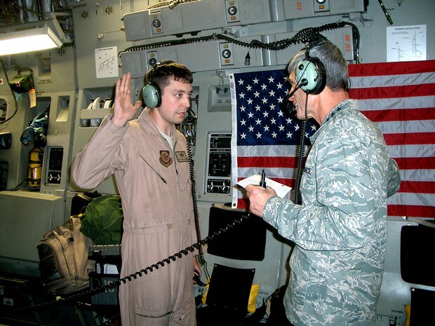 Air Force Chief of Staff Gen. Norton A. Schwartz reenlists Senior Airman Tyrell Haney Oct. 23 in a ceremony aboard a C-17 Globemaster III cruising above the U.S. Central Command area of operations. Airman Haney is a 437th Aircraft Maintenance Squadron crew chief from Charleston Air Force Base, S.C. (U.S. Air Force photo/Senior Master Sgt. Sean E. Cobb) 