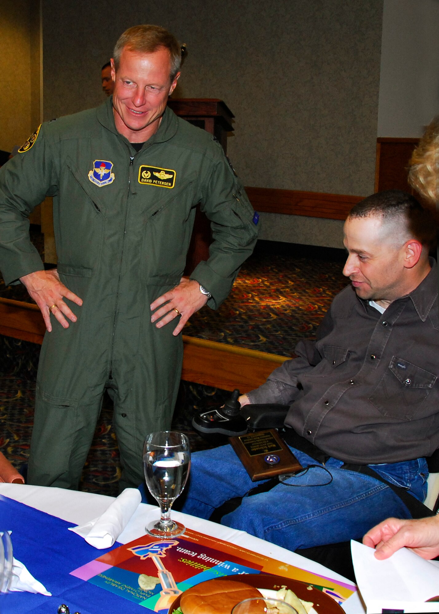 Col David Peterson, 80th Flying Training Wing commander, speaks with guest speaker Mark Schroeder at the Annual National Disability Employment Awareness Month luncheon held at the Sheppard Club Oct. 23. (U.S. Air Force photo/Harry Tonemah)