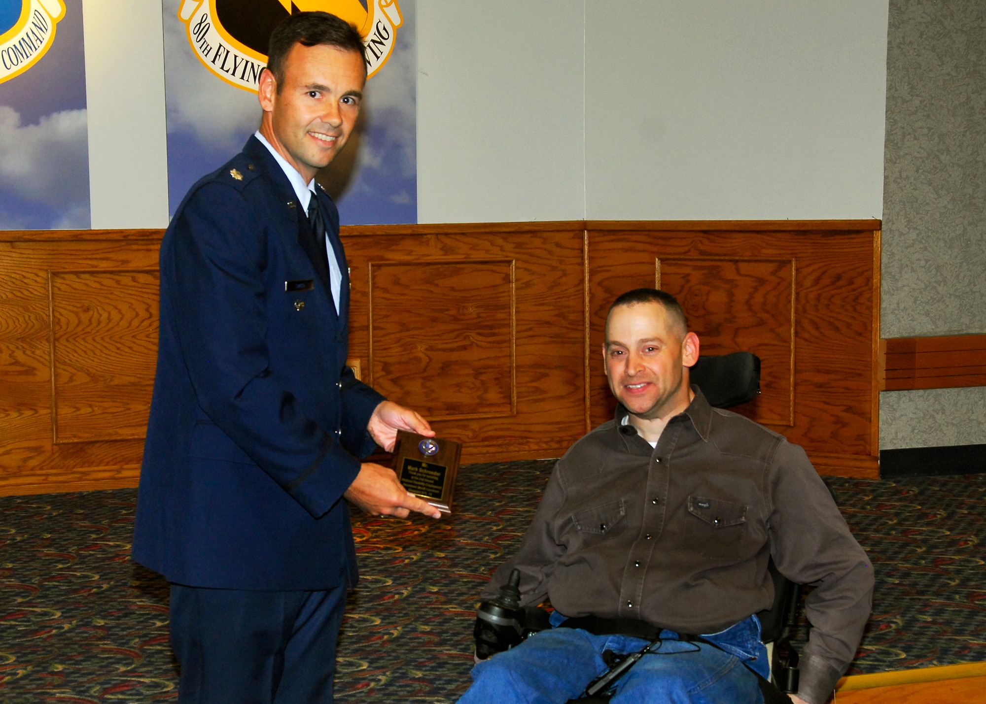 Lt. Col. Porter Smith, 82nd Mission Support Group Deputy Commander, presents Mark Schroeder, 82nd Communications Squadron, a plaque for speaking at the National Disability Employment Awareness Month luncheon Oct. 23 at the Sheppard Club. (U.S. Air Force photo/Harry Tonemah)