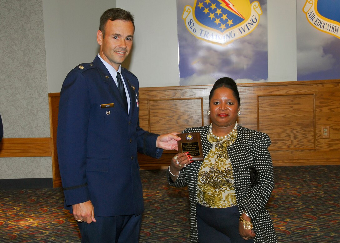 Lt. Col. Porter Smith, 82nd Mission Support Group Deputy Commander, presents Pearlene Carr, 82nd Contracting Squadron, a plaque for speaking at the National Disability Employment Awareness Month luncheon Oct. 23 at the Sheppard Club. (U.S. Air Force photo/Harry Tonemah)