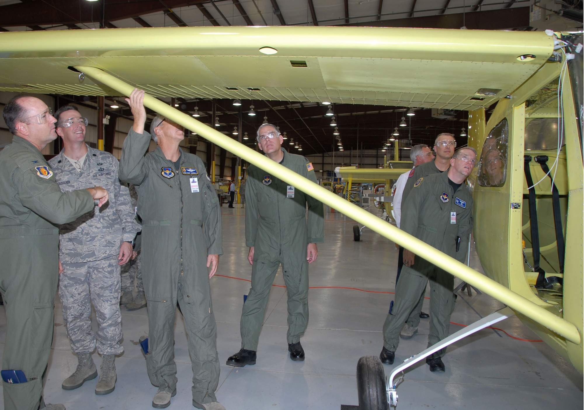 Col. Stuart Shaw, 97th Air Mobility Wing vice commander, (L), and other Altus Air Force Base commanders toured Quartz Mountain Aerospace aircraft factory Oct. 21.  The local aircraft factory CEO Mark Arceiro invited the base’s leadership to visit the 11-E aircraft product area.  The Quartz Mountain Aerospace factory, founded in 1992, is the only one operating in the Altus area, and has recently finished the production of its 15th 11-E aircraft. (U.S Air Force photo/Cherice I. Bryant)