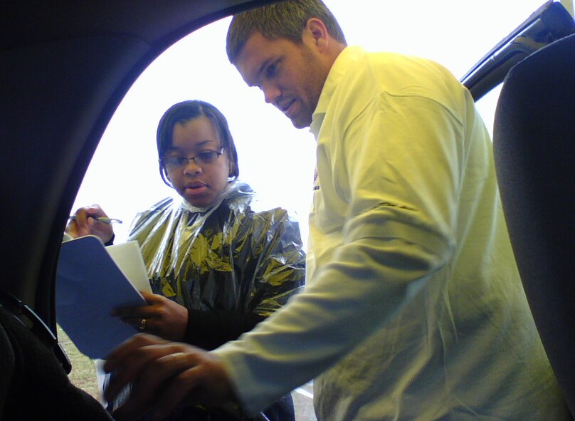 Child safety seat technicians Danielle Beverly and Brandon Bell perform a comprehensive check of Senior Airman Destiny Brison's vehicle to ensure proper child seat installation. More than 70 families from Wright-Patterson Air Force Base signed up to receive the free safety checks at North Child Development Center Oct. 24. The 88th Air Base Wing Safety Office and 88th Services Division Family Member Programs Flight teamed to host the event. Technicians identified installation errors in more than 80 percent of vehicles, including instances of recalled or defective child safety seats in nearly one out of every four vehicles inspected.  Recalled seats were replaced free of charge by event sponsor, Chrysler.  Inspectors said the results are not uncommon and encourage others to visit seatcheck.org for more information.  Both Beverly and Bell are employed by Evenflo of Miamisburg, Ohio.  (U.S. Air Force photo/Derek Kaufman)
