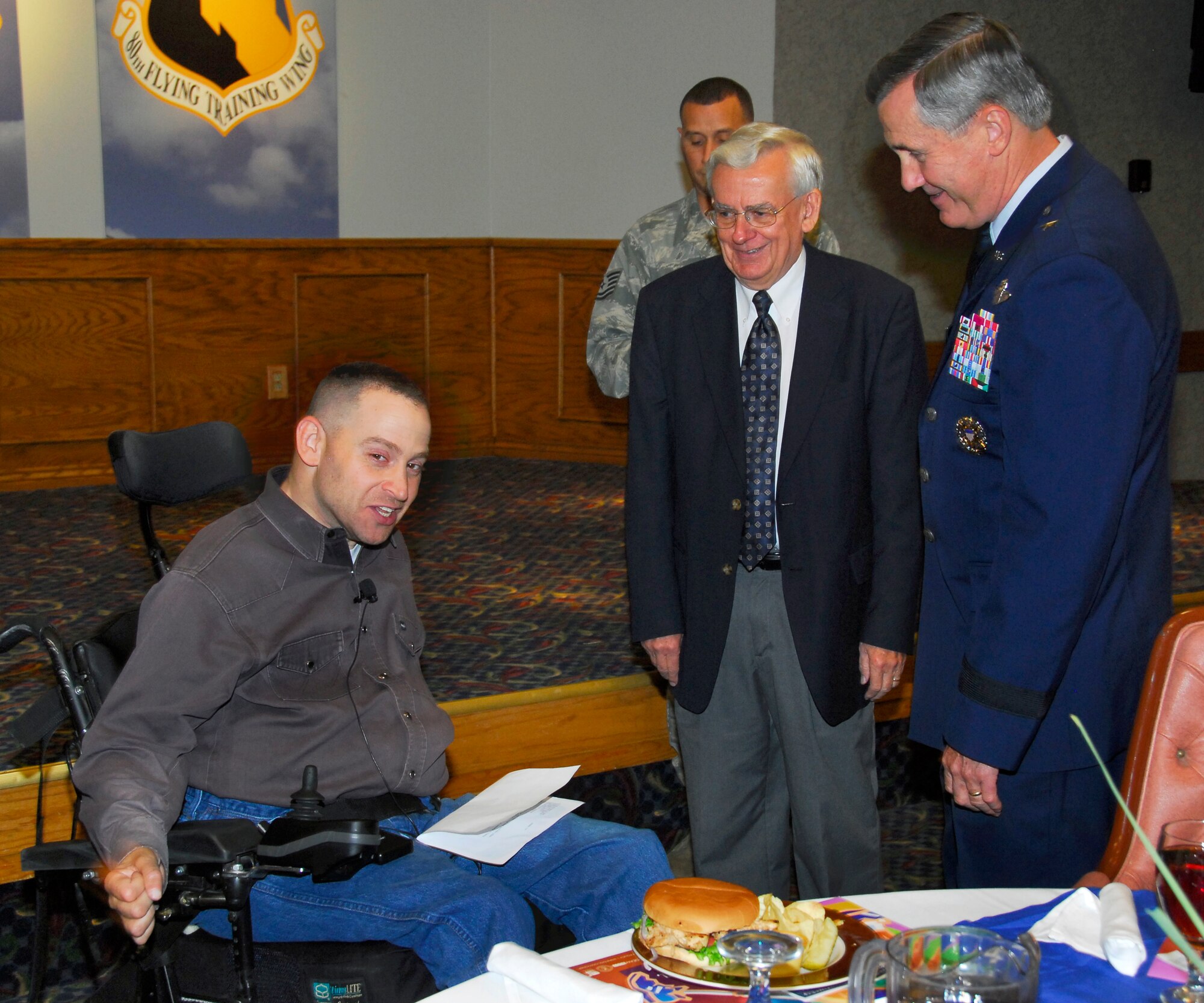 Mark Schroeder, a guest speaker with the 82nd Communications Squadron, is greeted by the mayor of Burkburnett Carl Law  and 82nd Training Wing commander O. G. Mannon before the annual National Disability Employment Awareness luncheon Oct. 23. (U.S. Air Force photo/Harry Tonemah) 