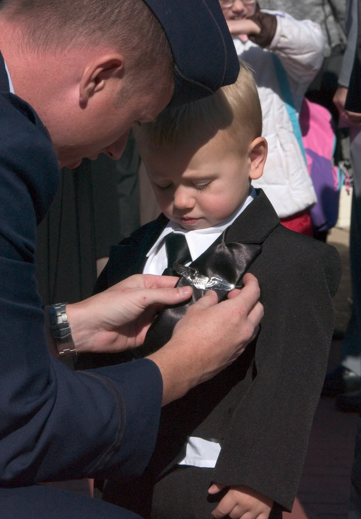 Second Lt. Steven Petersheim pins his newly-awarded pilot wings on his son, Koehler, after the graduation of Class 09-01, Friday, Oct. 24, here. Lieutenant Petersheim will fly KC-135s for the Ohio Air National Guard. Gen. Stephen Lorenz, the commander of Air Education and Training Command spoke at Class 09-01’s graduation. (U.S. Air Force photo by Staff Sgt. Brian Hill)