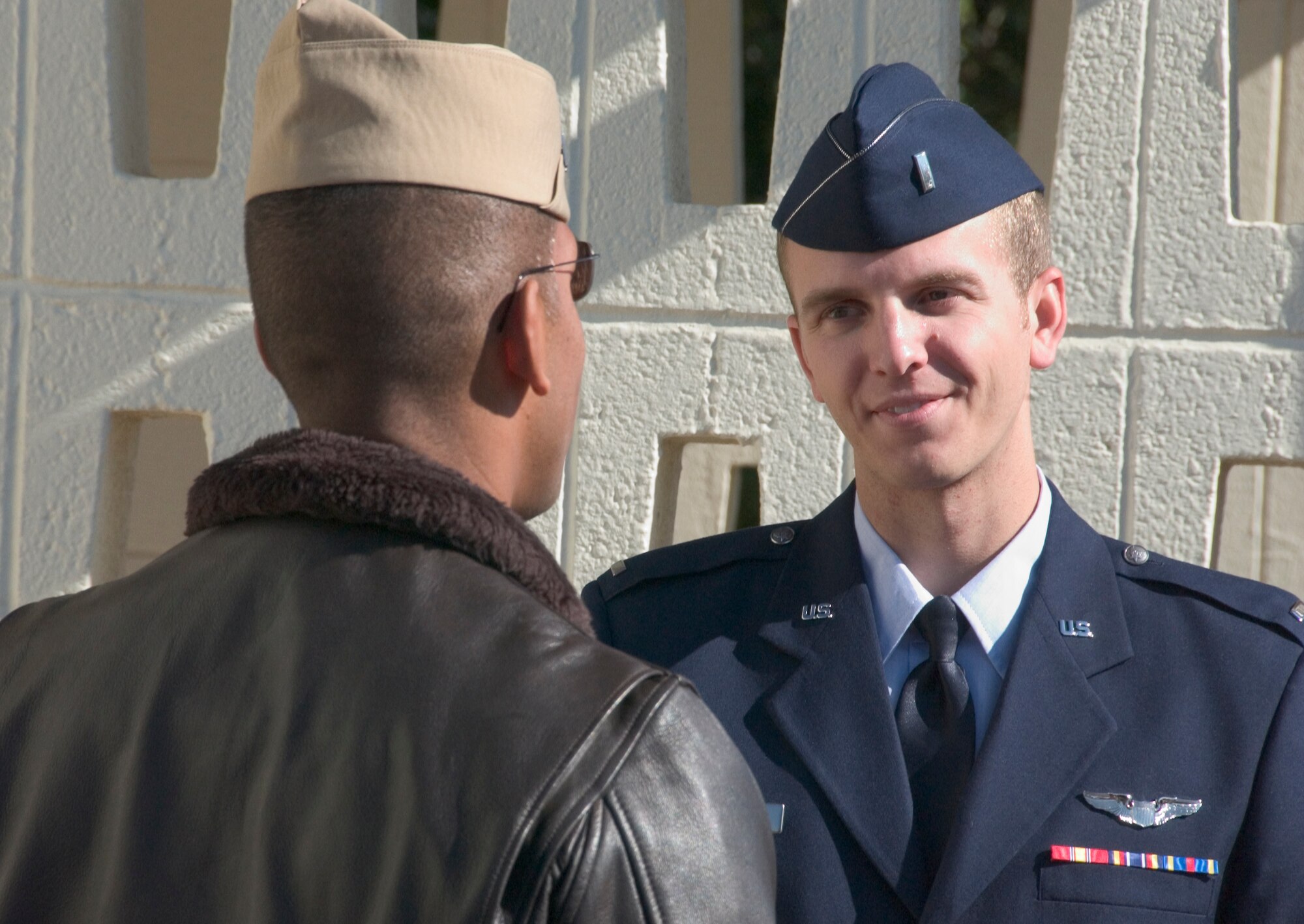 First Lt. Ryan Strand, right, a member of Class 09-01, talks with his flight commander, Navy Lt. Che Coleman, after the class graduation Friday, Oct. 24. Lieutenant Strand will be a T-6 instructor pilot with the 33rd Flying Training Squadron here. Gen. Stephen Lorenz, the commander of Air Education and Training Command spoke at Class 09-01’s graduation. (U.S. Air Force photo by Staff Sgt. Brian Hill)