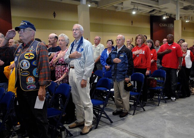 Attendees stand for the National Anthem during the closing ceremony for The Moving Wall display at the North Charleston Performing Arts Center in North Charleston, S.C., Oct. 18. Airmen, Sailors, Soldiers, Marines and Coast Guardsmen stood watch 24 hours a day from Oct. 16 to 20 at the wall which is a half-size replica of the Vietnam Veterans National Memorial, The Wall, located in Washington, D.C. (U.S. Air Force photo/Airman 1st Class Katie Gieratz)
