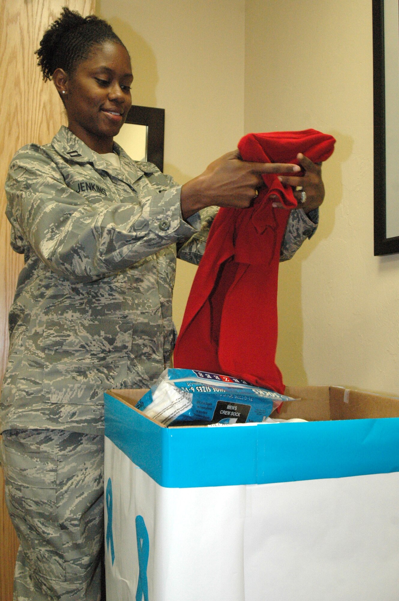 Capt. Rubanette Jenkins, victims advocate with the 507th Air Refueling Wing, sorts through items in a box ment to go to victims of domestic violence and sexual assault. Donated items will be given to the YWCA of Oklahoma City, the Rape Crisis Center and the Domestic Violence Shelter. Victims of sexual assault and domestic violence often lose their clothing as evidence when they submit to a forensic exam or flee a violent home. Therefore, they have nothing to wear, creating a desperate need for underwear, socks, sweat suits, T-shirts, flip-flops, sports bras, and travel size toiletry items. Donated items need not be expensive, but they must be new.  Any and all styles and sizes will do. Items for men are needed, too. Drop boxes are located in various locations throughout Tinker AFB until Oct. 31.  For further information contact the Sexual Assault Prevention and Response Office at 734-9293 or the Family Advocacy Program 734-4390. (Air Force photo/Danielle Gregory)
