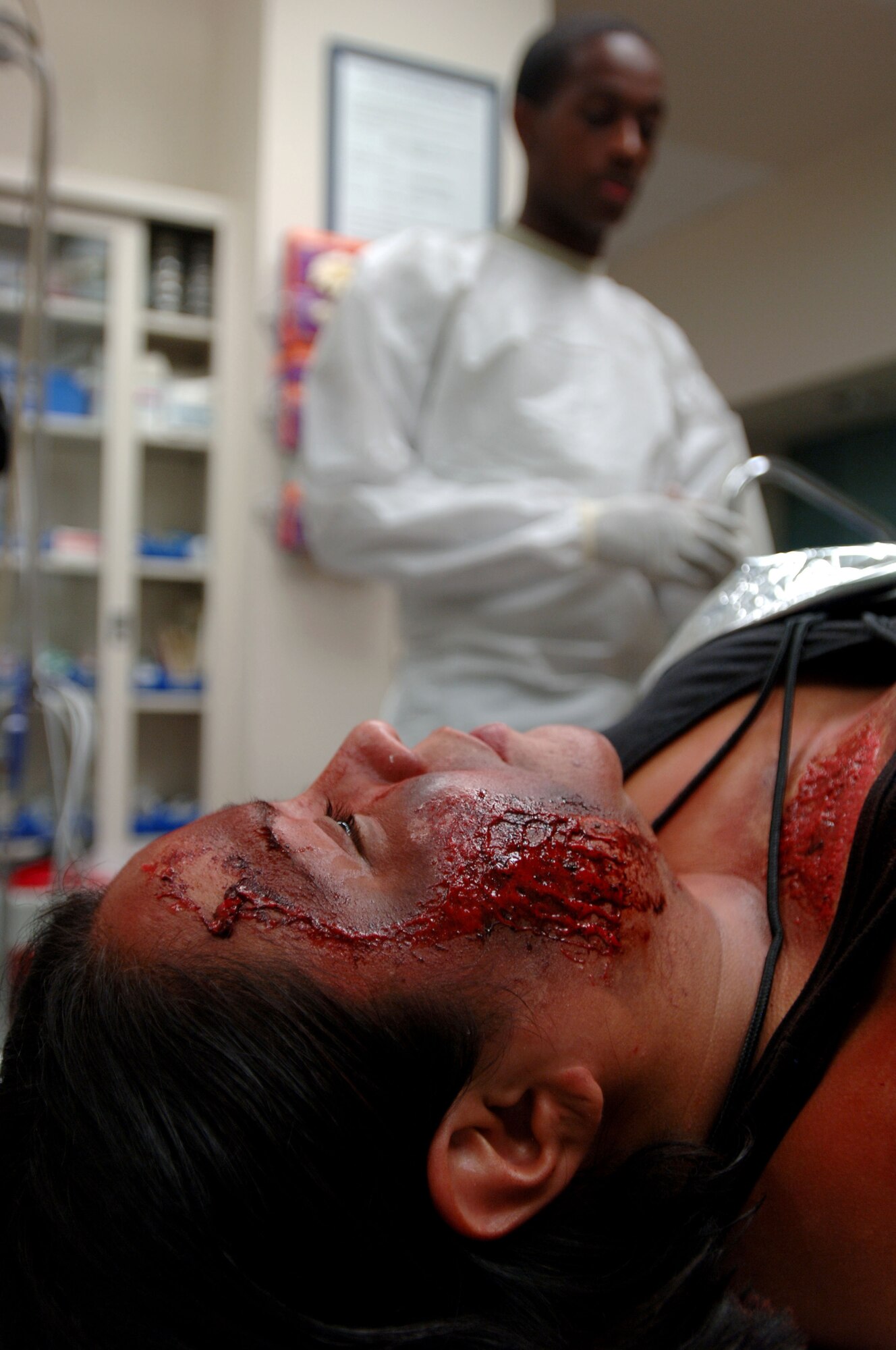 Senior Airman Demorris Byrd, medical technician, 59th Emergency Medical Squadron, evaluates a patient's simulated injuries in the Wilford Hall Medical Center Emergency Department Oct. 23. Wilford Hall members participated in a mass casualty city-wide exercise here. (U.S. Air Force photo by Staff Sgt. Erin M. Peterson)