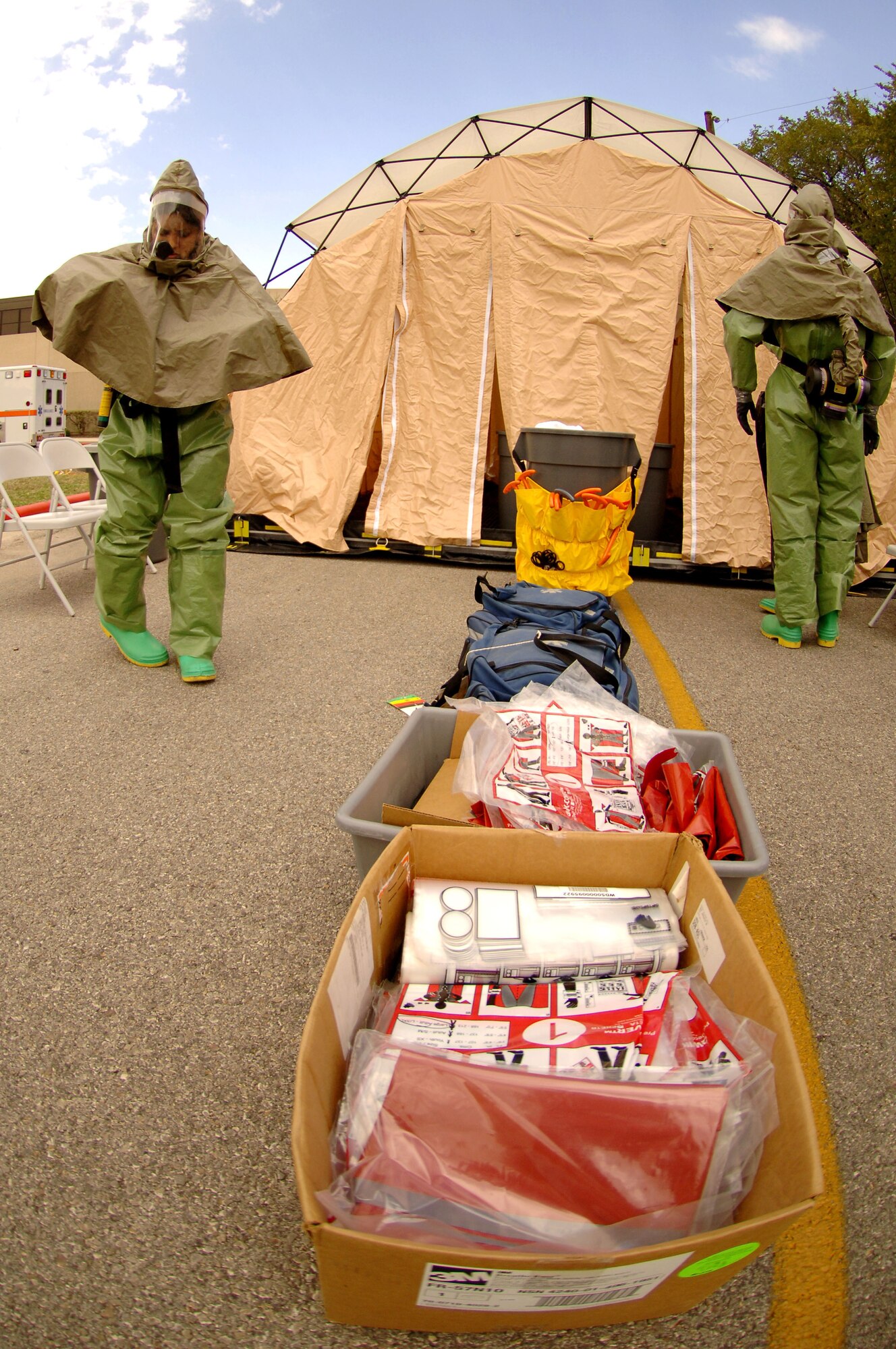 Members of the 59th Medical Wing Decontamination Team suit up at Wilford Hall Medical Center, Lackland Air Force Base, Texas, Oct. 23.  59th MDW staff participated in a mass casualty city-wide exercise. (U.S. Air Force photo by Staff Sgt. Erin M. Peterson)